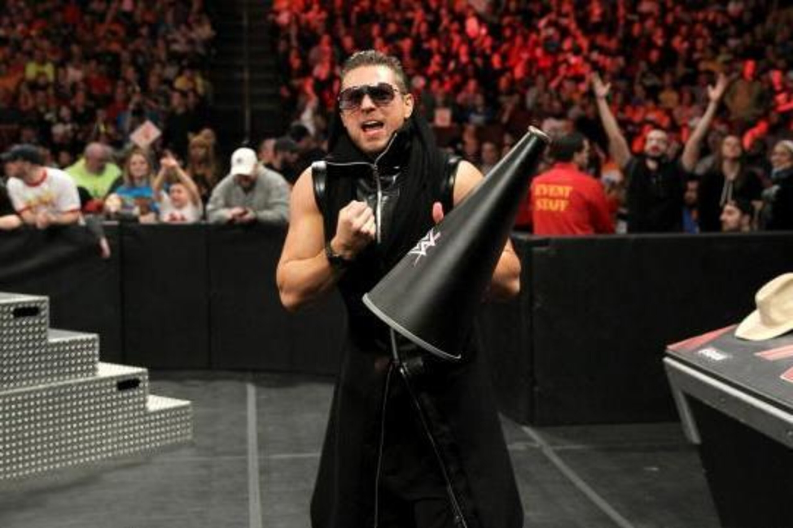 The Miz coaches Neville at ringside. The Miz coaches Neville at ringside.