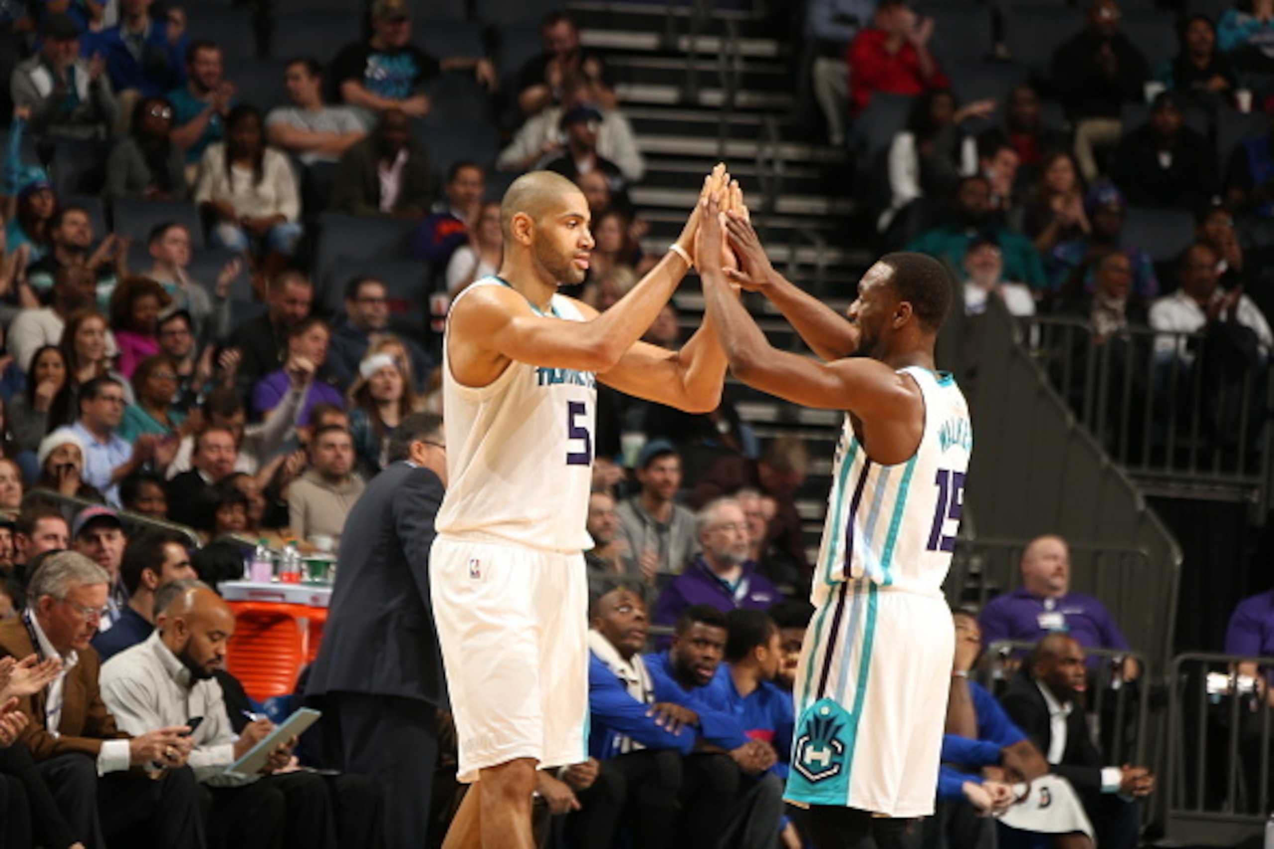 CHARLOTTE, NC - DECEMBER 7:  Nicolas Batum #5 of the Charlotte Hornets high fives Kemba Walker #15 of the Charlotte Hornets on December 7, 2015 at Time Warner Cable Arena in Charlotte, North Carolina. NOTE TO USER: User expressly acknowledges and agrees t