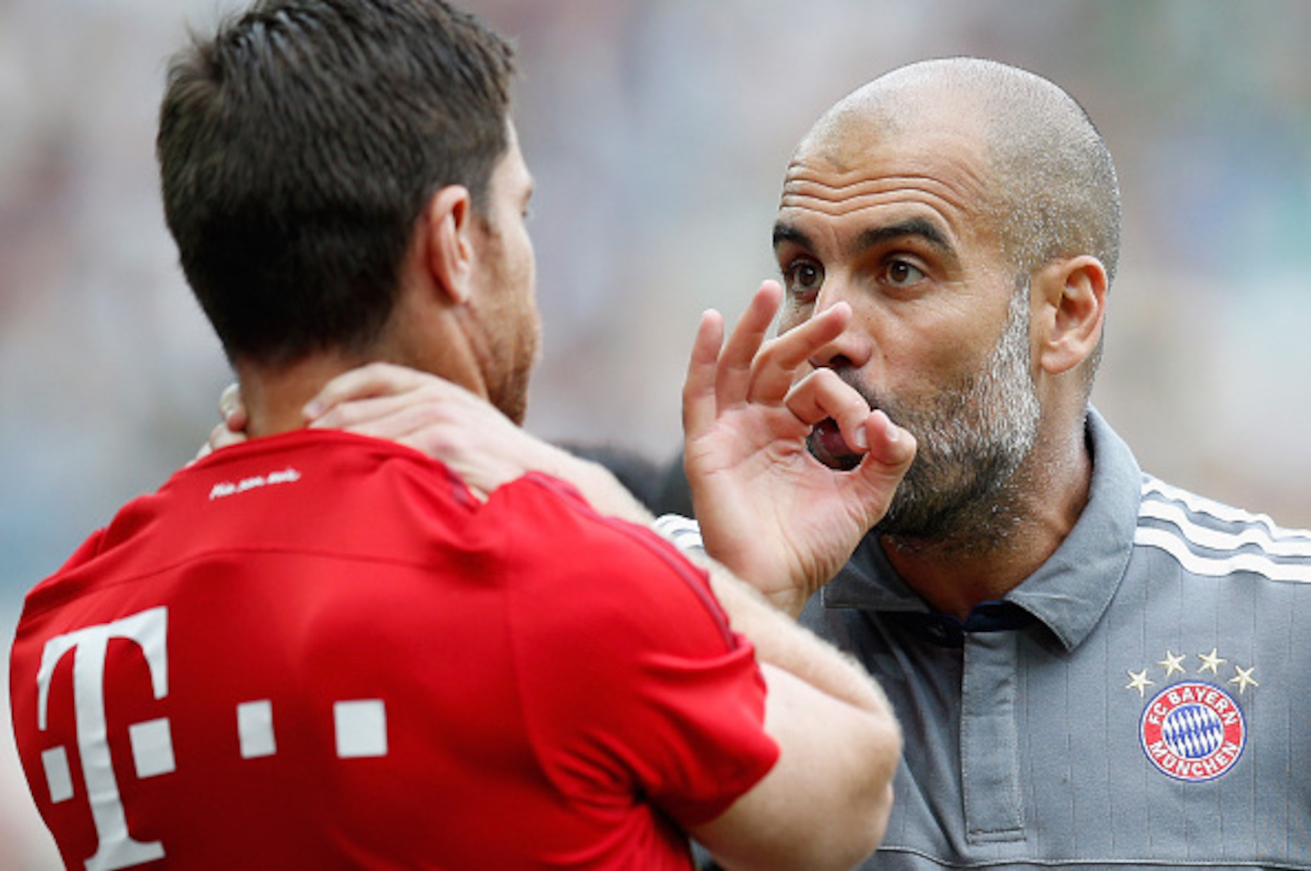 MOENCHENGLADBACH, GERMANY - JULY 12:  Head coach Pep Guardiola of Bayern talks to Xabi Alsonso during the Telekom Cup 2015 third place match between Borussia Moenchengladbach and FC Bayern Muenchen at Borussia-Park on July 12, 2015 in Moenchengladbach, Ge