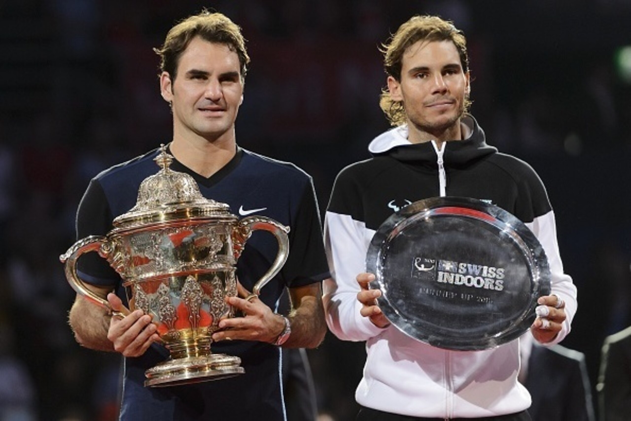 Switzerland's Roger Federer (L) poses with his trophy next to Spain's Rafael Nadal after Federer won their final match at the Swiss Indoors tennis tournament on November 1, 2015 in Basel, northern Switzerland.  AFP PHOTO / FABRICE COFFRINI        (Photo c