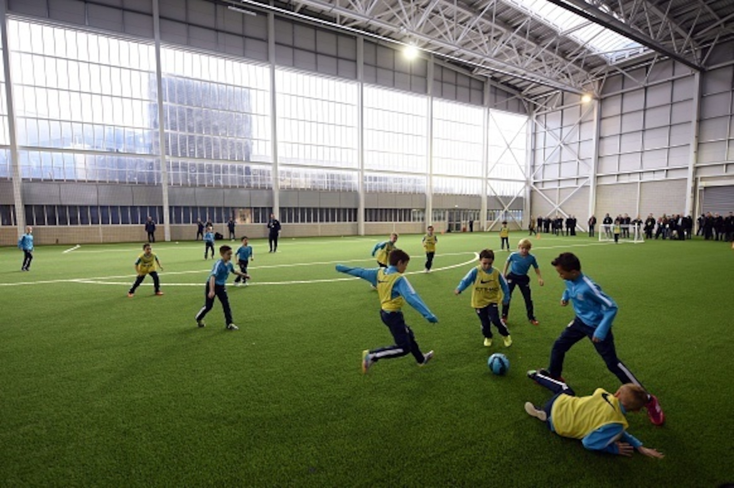 Young Manchester City Academy footballers play in The Performance Centre at the newly opened City Football Academy in Manchester, Northern England, on December 8, 2014. AFP PHOTO / OLI SCARFF  RESTRICTED TO EDITORIAL USE. No use with unauthorized audio, v