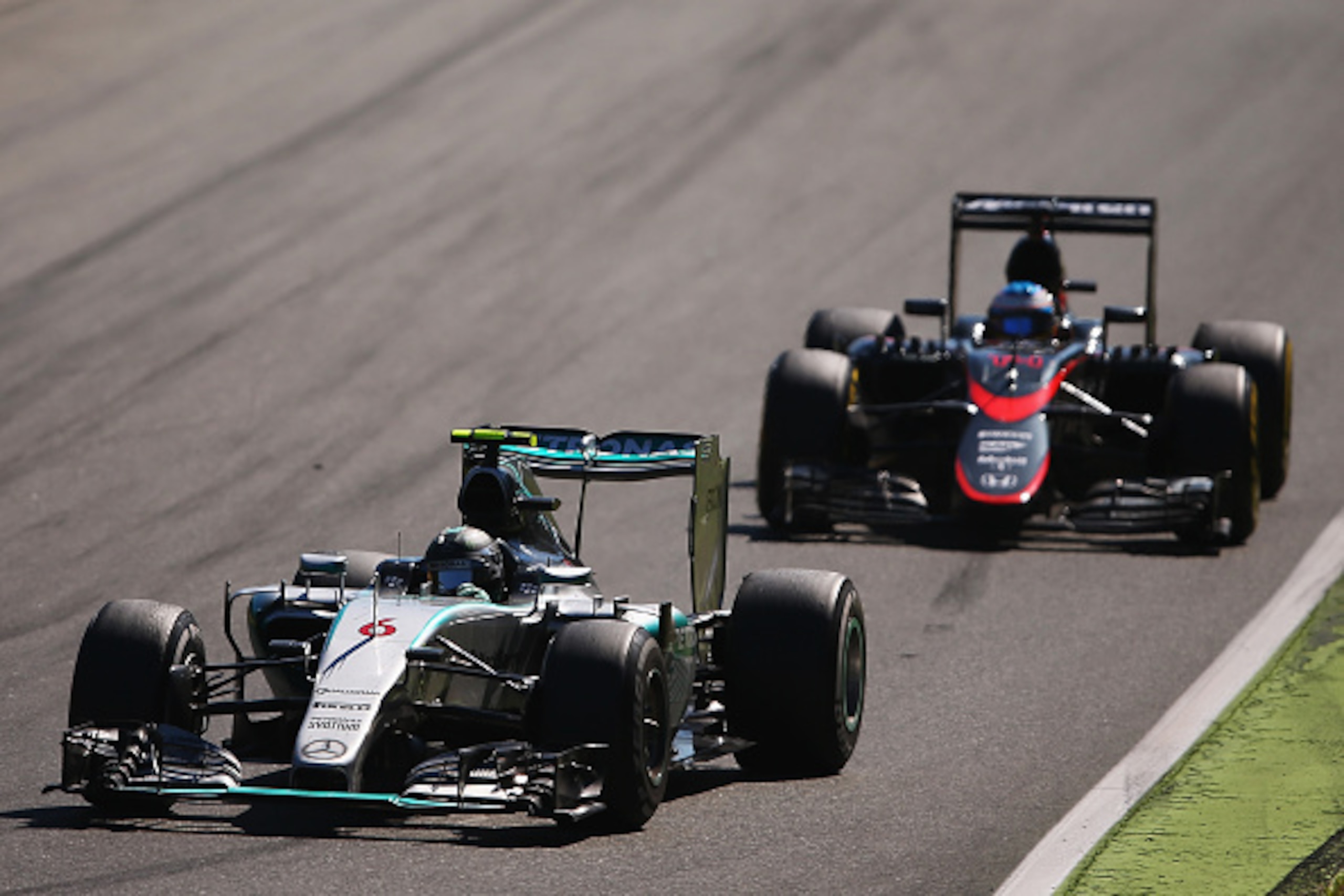 MONZA, ITALY - SEPTEMBER 06:  Nico Rosberg of Germany and Mercedes GP drives ahead of Fernando Alonso of Spain and McLaren Honda during the Formula One Grand Prix of Italy at Autodromo di Monza on September 6, 2015 in Monza, Italy.  (Photo by Bryn Lennon/