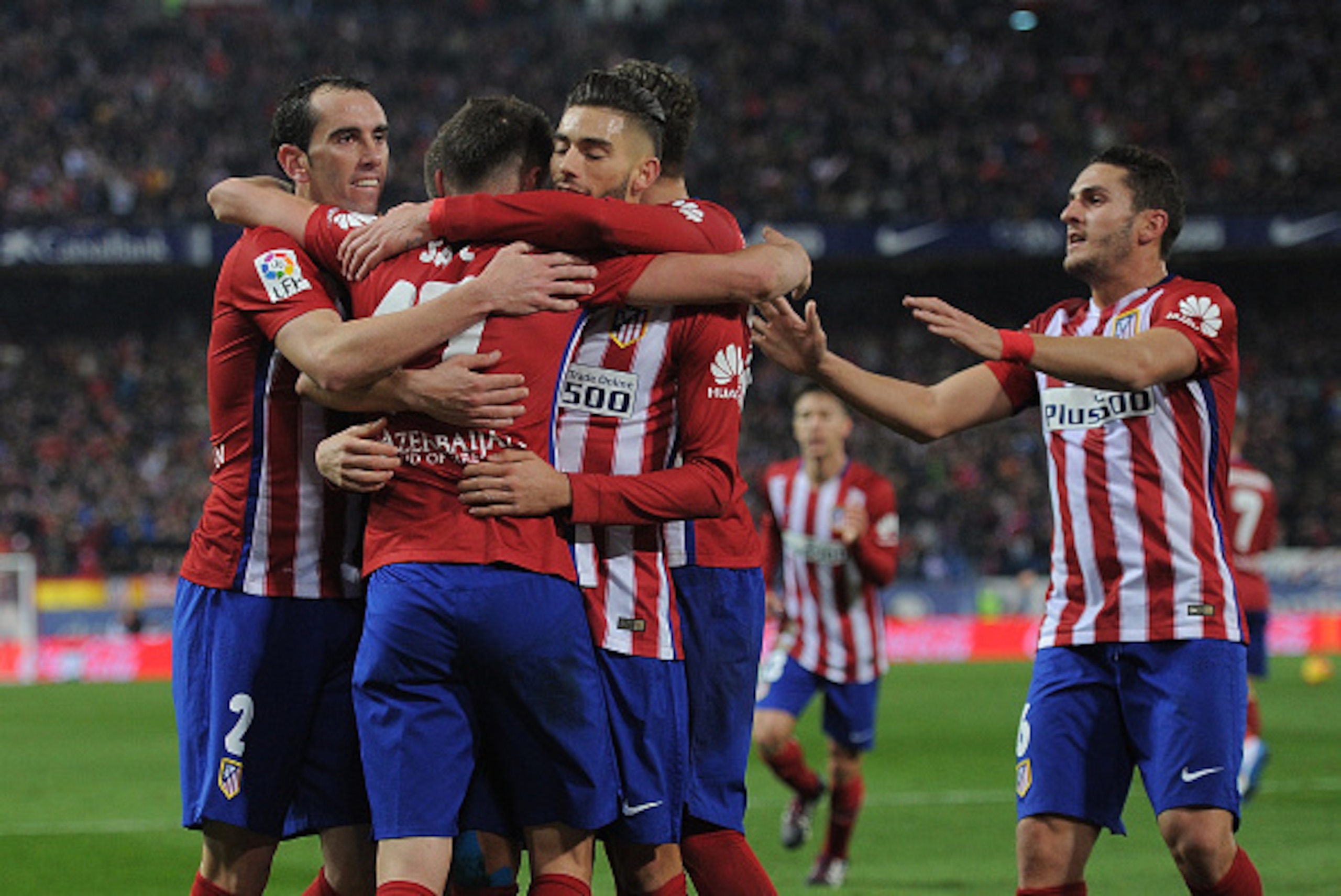 MADRID, SPAIN - DECEMBER 13:  Saul Niguez of Club Atletico de Madrid celebrates with Diego Godin after scoring his team's opening goal during the La Liga match between Club Atletico de Madrid and Athletic Club at Vicente Calderon Stadium on December 13, 2