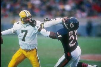 27 Nov 1988:  Quarterback Don Majkowski of the Green Bay Packers (left) attempts to evade Chicago Bears defensive back Dave Duerson during a game at Soldier Field in Chicago, Illinois.  The Bears won the game, 16-0. Mandatory Credit: Jonathan Daniel  /All
