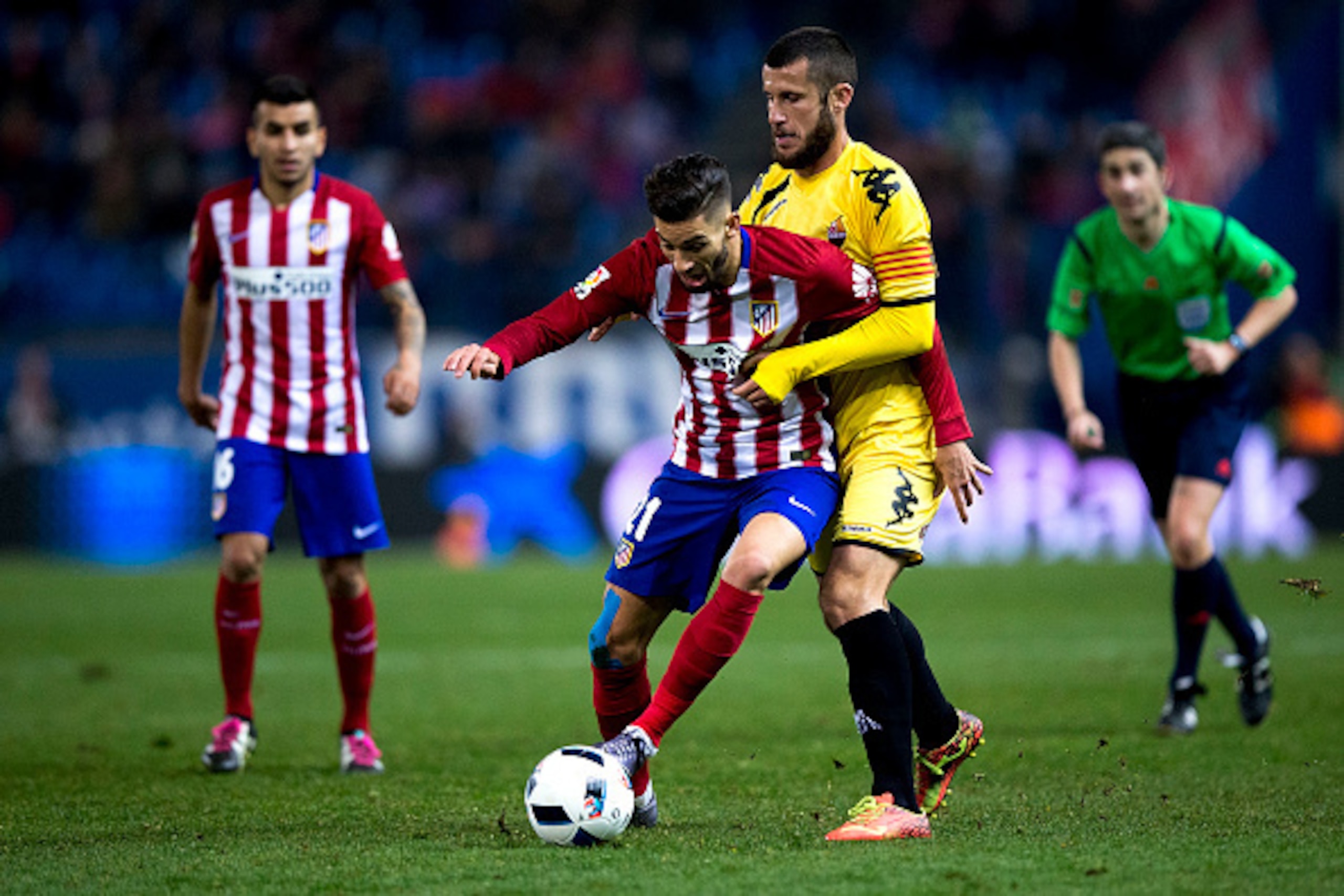 MADRID, SPAIN - DECEMBER 17:  Yannick Carrasco (L) of Atletico de Madrid competes for the ball with Alex Colorado (R) of CF Reus during the Copa del Rey Round of 32 match between Club Atletico Madrid and CF Reus Deportiu at Vicente Claderon stadium on Dec