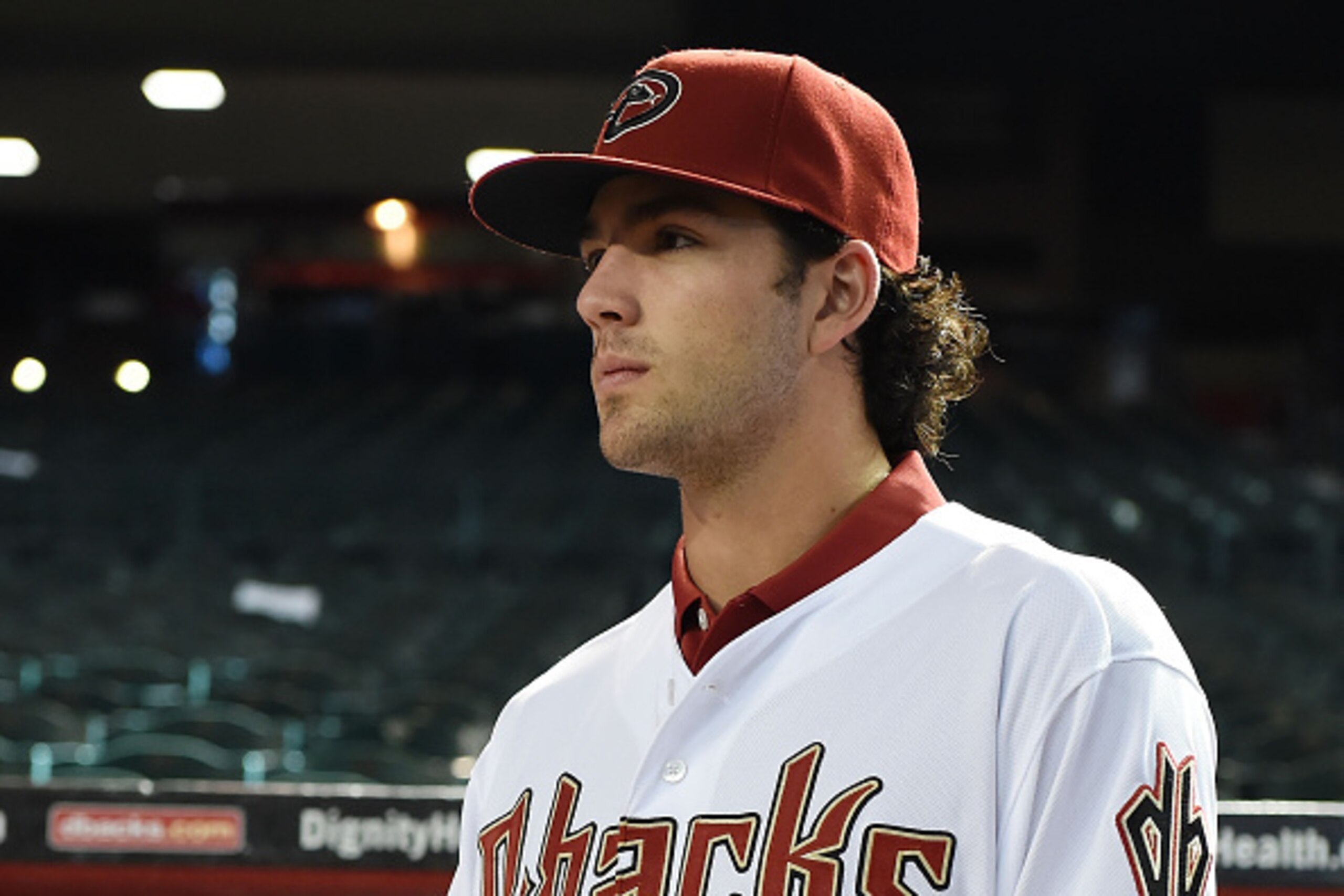 PHOENIX, AZ - JULY 20:  Dansby Swanson of the Arizona Diamondbacks, the first overall pick in the 2015  Major League Baseball draft, watches batting practice prior to a game against the Miami Marlins at Chase Field on July 20, 2015 in Phoenix, Arizona.  (