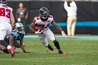 Dec 13, 2015; Charlotte, NC, USA; Atlanta Falcons running back Devonta Freeman (24) runs the ball during the third quarter against the Carolina Panthers at Bank of America Stadium. Panthers defeated the Falcons 38-0. Mandatory Credit: Jeremy Brevard-USA T