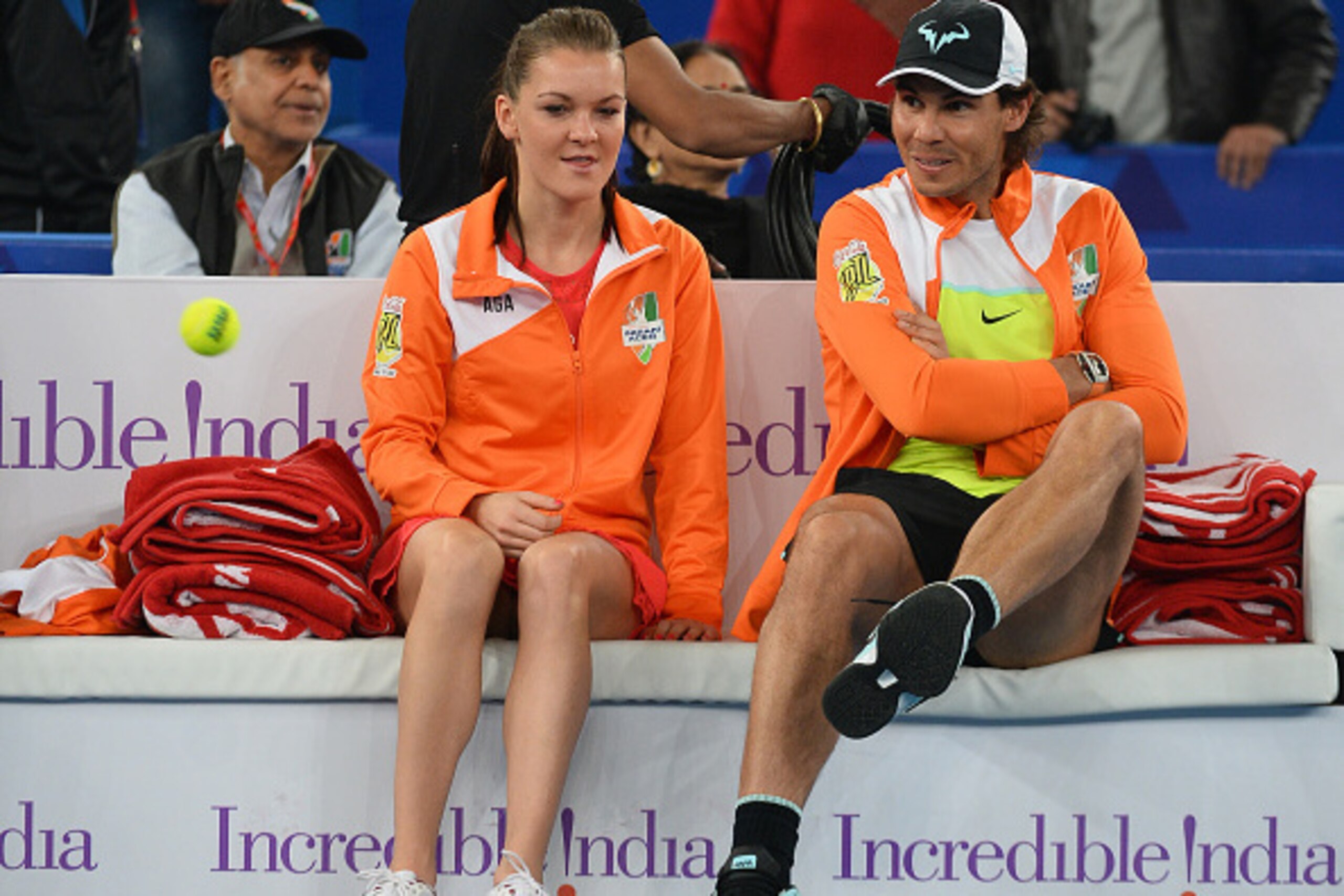 Poland's Agnieszka Radwanska of the Indian Aces (L) looks on as teammate Spain's Rafael Nadal kicks a ball during the International Premier Tennis League (IPTL) tennis match between Indian Aces and Philippine Mavericks in New Delhi on December 10, 2015.  