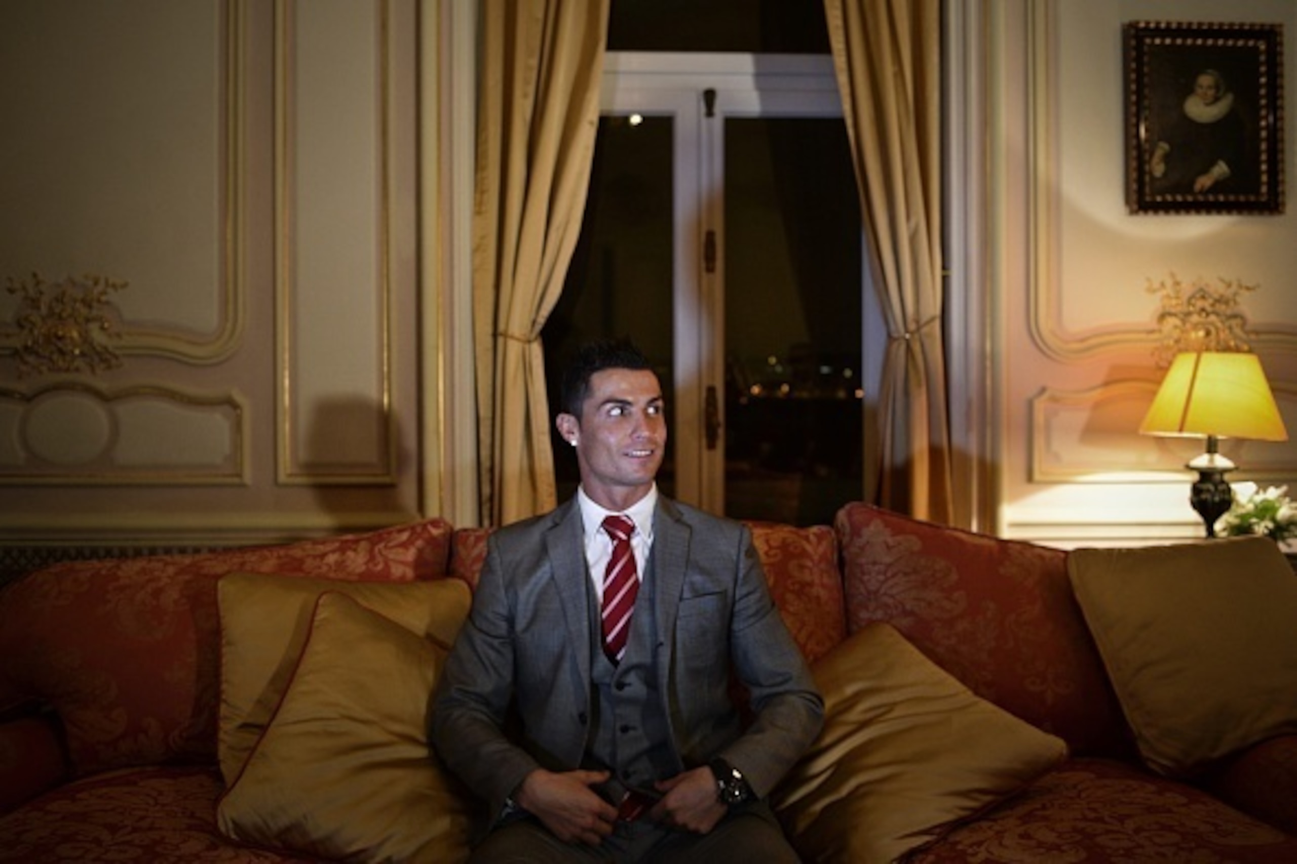 Real Madrid's player Cristiano Ronaldo looks on as he poses for a photo after attending an AFP interview at Pestana Hotel Palace in Lisbon on December 17, 2015. Cristiano Ronaldo will invest over 37 million euros in the Pestana hotel group to create four 
