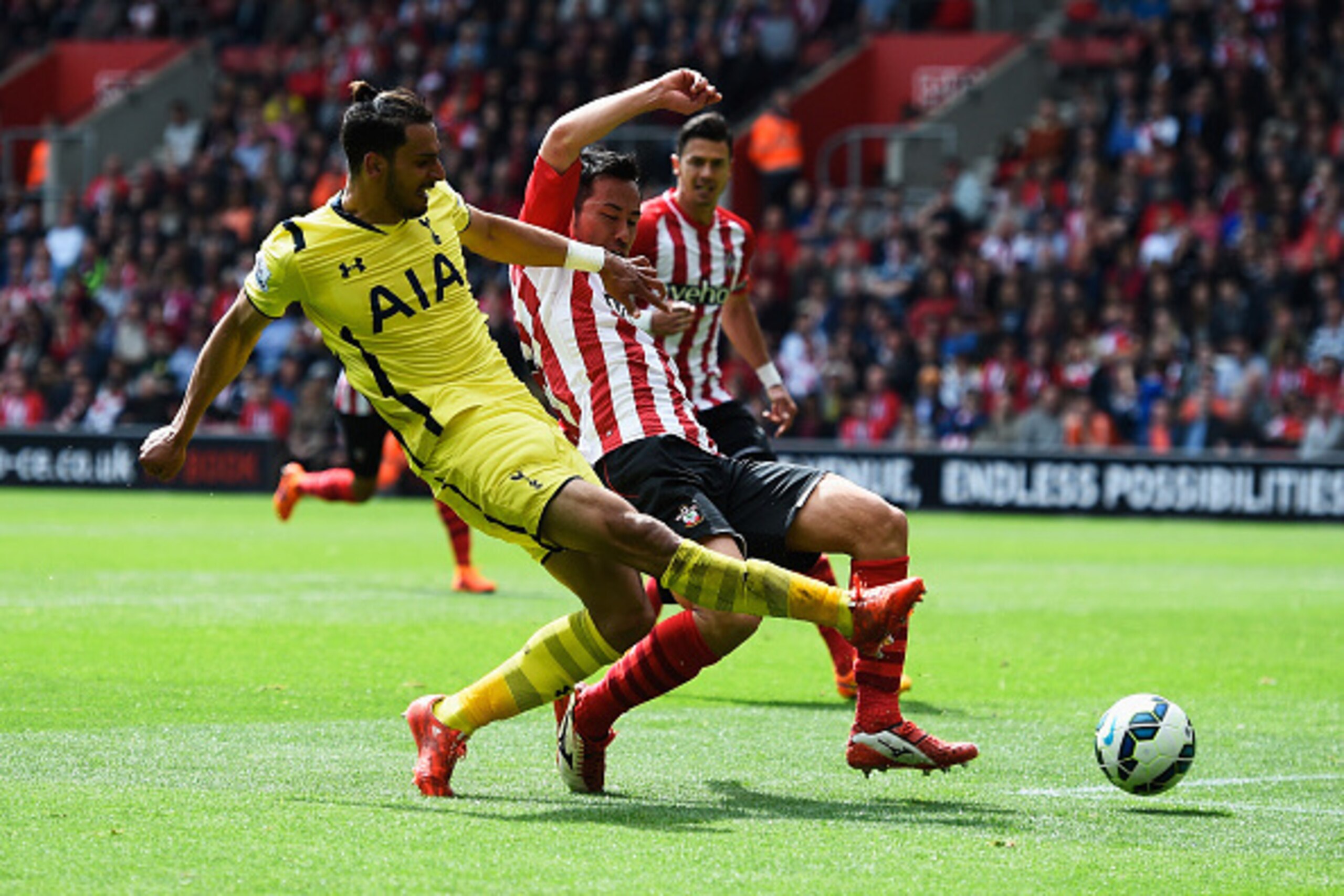 SOUTHAMPTON, ENGLAND - APRIL 25:  Nacer Chadli of Spurs shoots past Maya Yoshida of Southampton to score their second goal during the Barclays Premier League match between Southampton and Tottenham Hotspur at St Mary's Stadium on April 25, 2015 in Southam