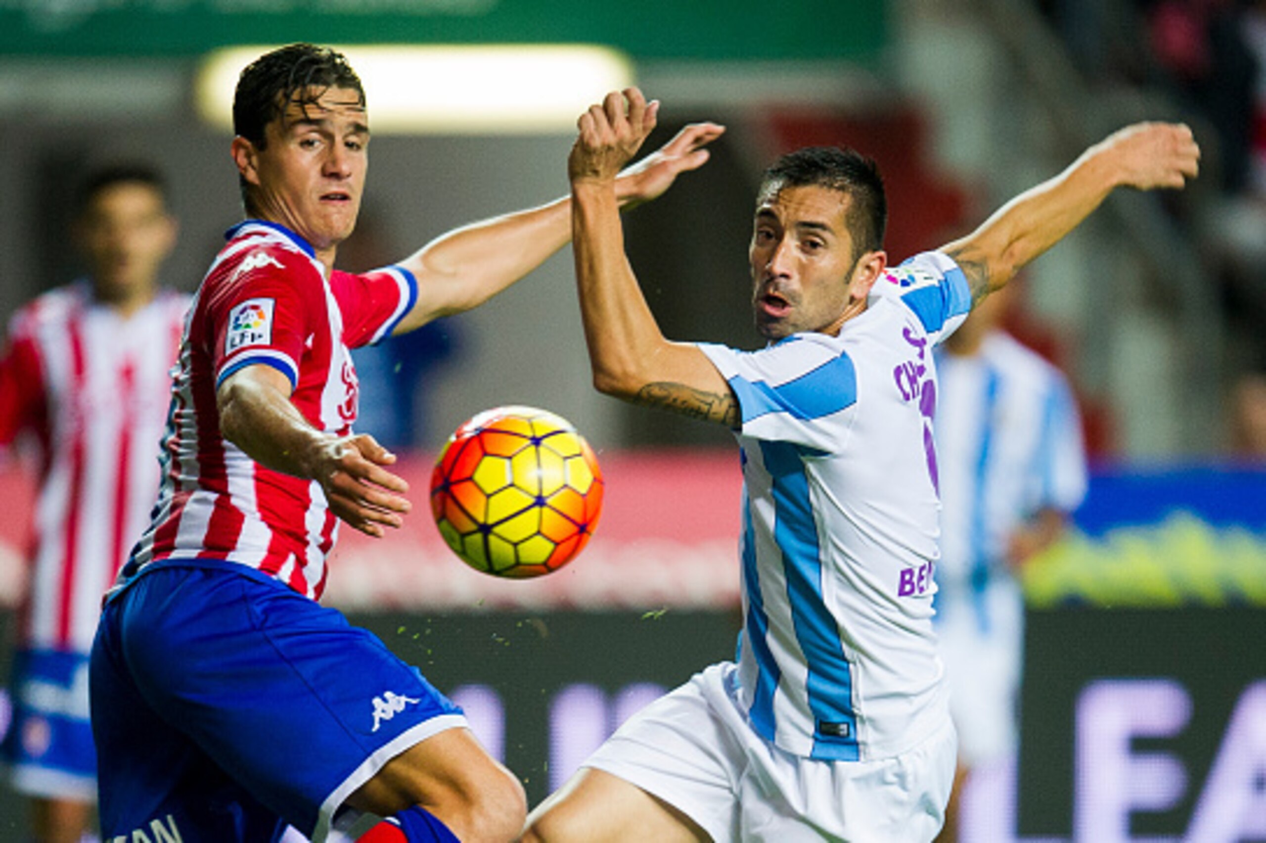 GIJON, SPAIN - NOVEMBER 01:  Bernardo Espinosa of Real Sporting de Gijon duels for the ball with Charles of Malaga CF during the La Liga match between Real Sporting de Gijon and Malaga CF at Estadio El Molinon on November 1, 2015 in Gijon, Spain.  (Photo 
