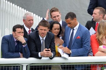 Manchester United's English defender Rio Ferdinand (C) signs an autograph next to Manchester United's English midfielder Michael Carrick (2R) at the Chester Races horse racing event at Chester Racecourse in Cheshire, northwest England on May 8, 2013. Alex