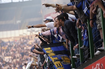Inter fans watch their team win the treble.