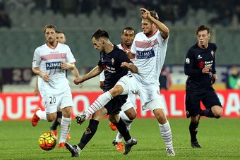 FLORENCE, ITALY - DECEMBER 16: Nikola Kalinic of ACF Fiorentina battles for the ball with Lorenzo Lollo of Carpi Fc during the TIM Cup match between ACF Fiorentina and Carpi FC at Stadio Artemio Franchi on December 16, 2015 in Florence, Italy.  (Photo by 