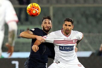 FLORENCE, ITALY - DECEMBER 16: Gonzalo Rodriguez of ACF Fiorentina battles for the ball with Marco Borriello of Carpi Fc during the TIM Cup match between ACF Fiorentina and Carpi FC at Stadio Artemio Franchi on December 16, 2015 in Florence, Italy.  (Phot
