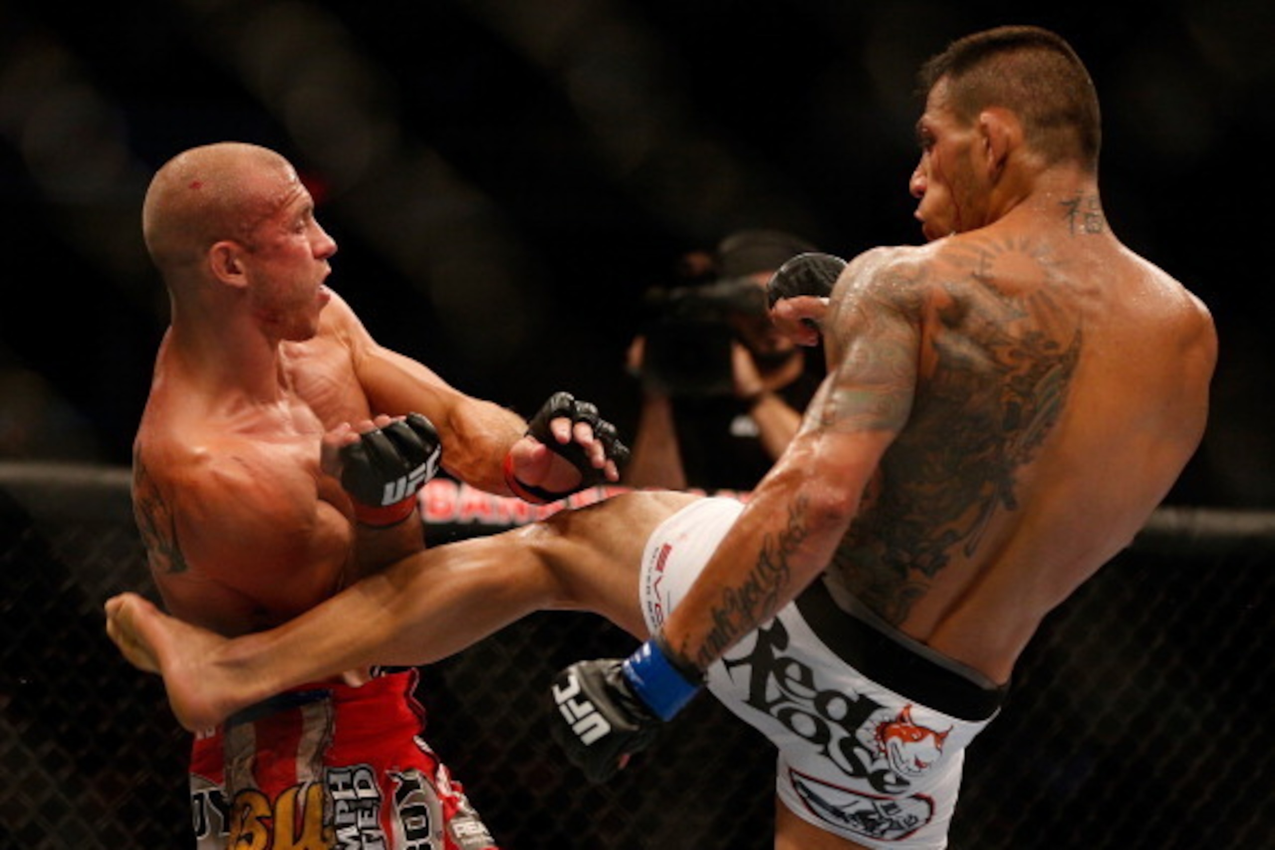 INDIANAPOLIS, IN - AUGUST 28:  (R-L) Rafael dos Anjos kicks Donald 'Cowboy' Cerrone in their lightweight fight during the UFC on FOX Sports 1 event at Bankers Life Fieldhouse on August 28, 2013 in Indianapolis, Indiana. (Photo by Josh Hedges/Zuffa LLC/Zuf