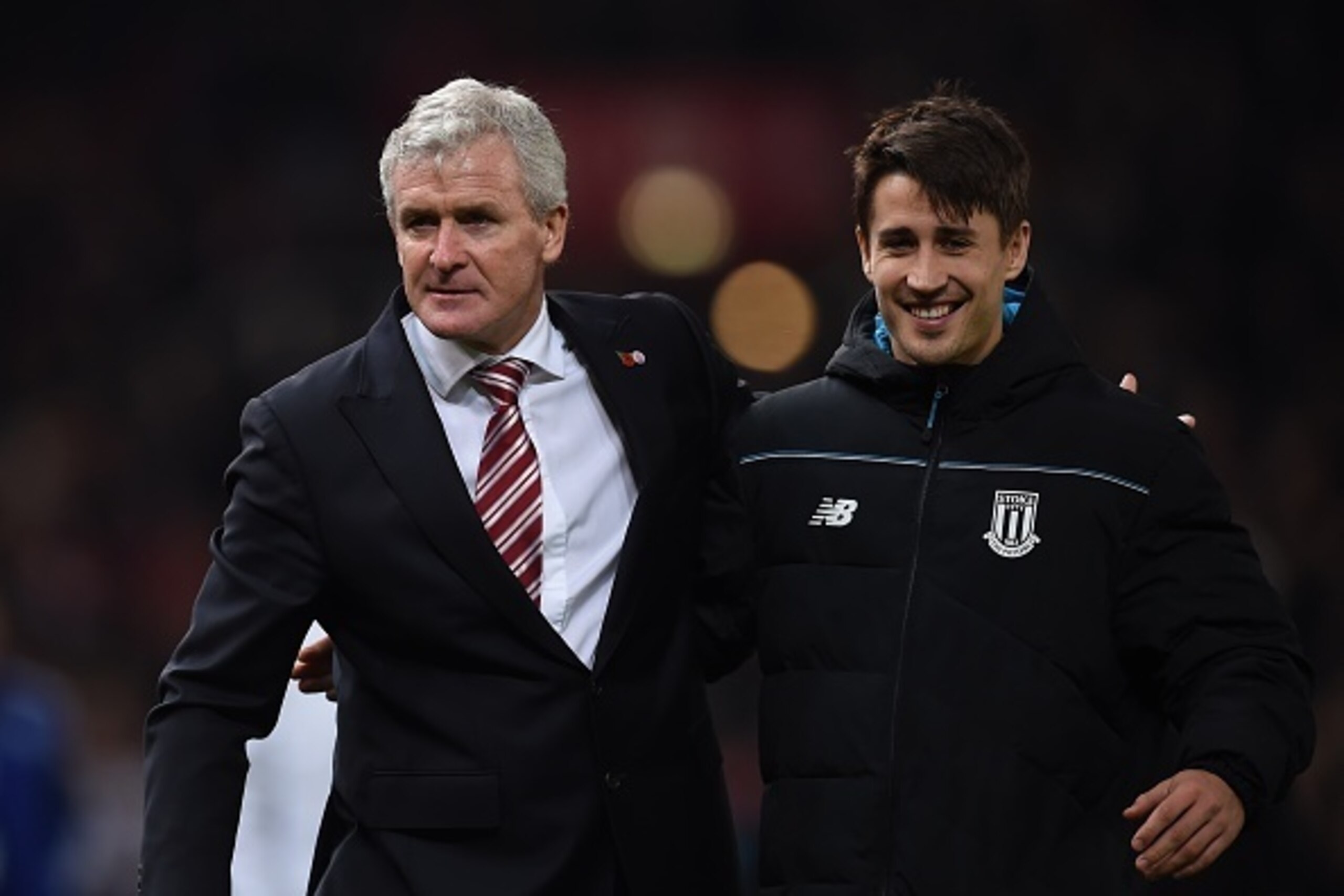 Stoke City's Welsh manager Mark Hughes (L) celebrates with Stoke City's Spanish striker Bojan Krkic as they leave the pitch after the English Premier League football match between Stoke City and Chelsea at the Britannia Stadium in Stoke-on-Trent, central 