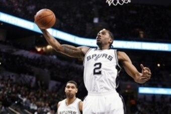 Dec 14, 2015; San Antonio, TX, USA; San Antonio Spurs small forward Kawhi Leonard (2) grabs a rebound during the first half against the Utah Jazz at AT&T Center. Mandatory Credit: Soobum Im-USA TODAY Sports