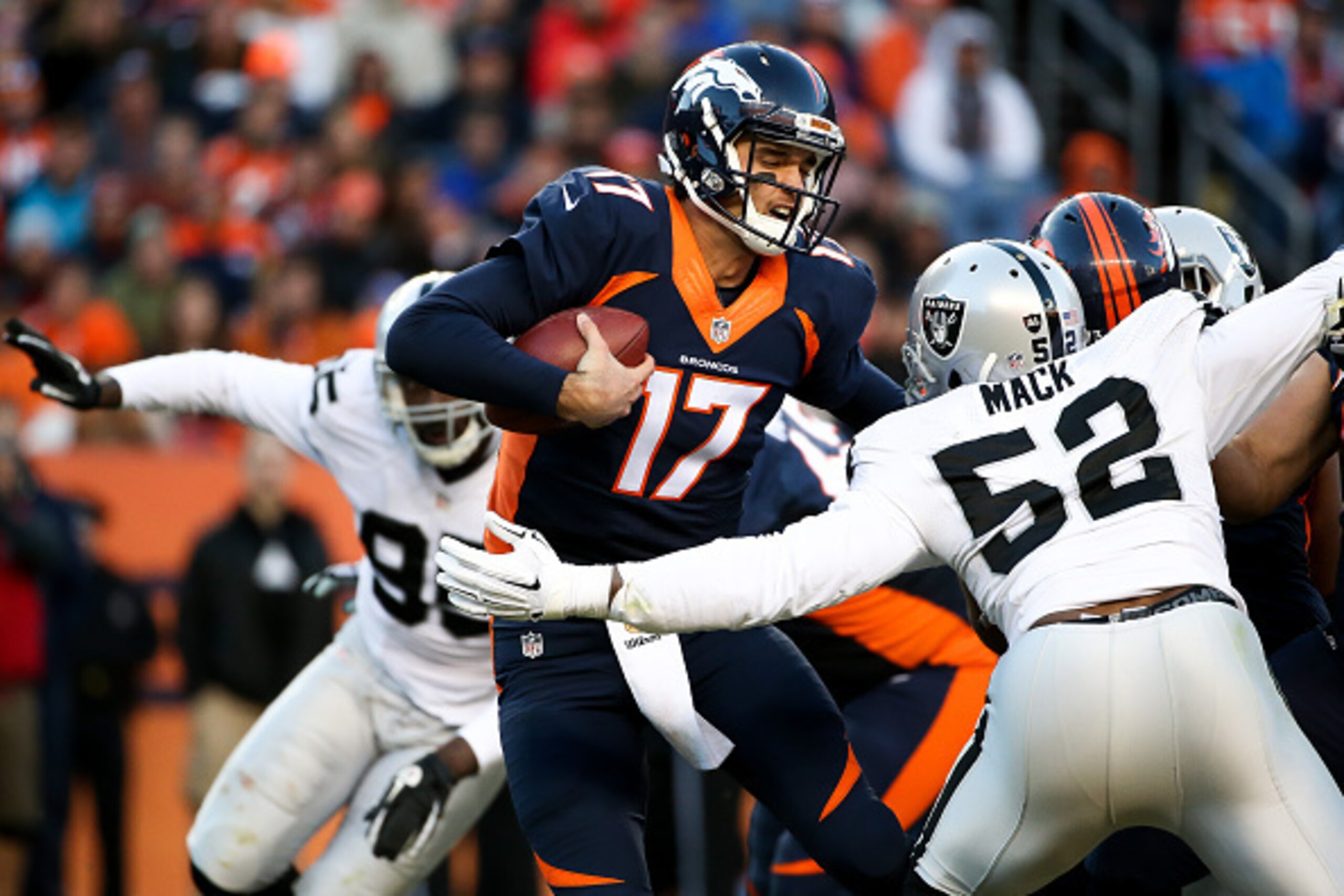 DENVER, CO - DECEMBER 13:  Quarterback Brock Osweiler #17 of the Denver Broncos scrambles away from defensive end Khalil Mack #52 and defensive end Benson Mayowa #95 of the Oakland Raiders during a game at Sports Authority Field at Mile High on December 1