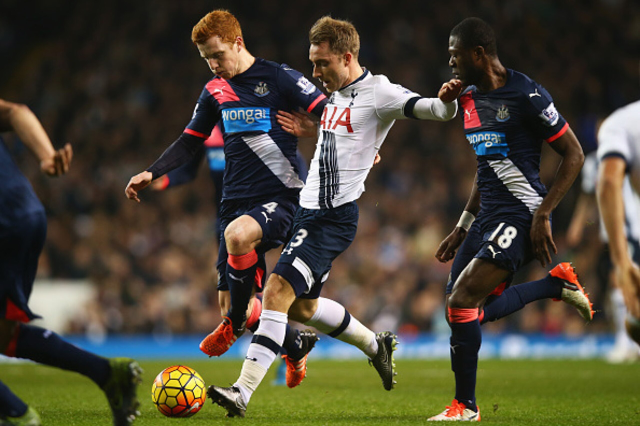LONDON, ENGLAND - DECEMBER 13:  Christian Eriksen of Tottenham Hotspur takes on Jack Colback (4) and Chancel Mbemba of Newcastle United during the Barclays Premier League match between Tottenham Hotspur and Newcastle United at White Hart Lane on December 