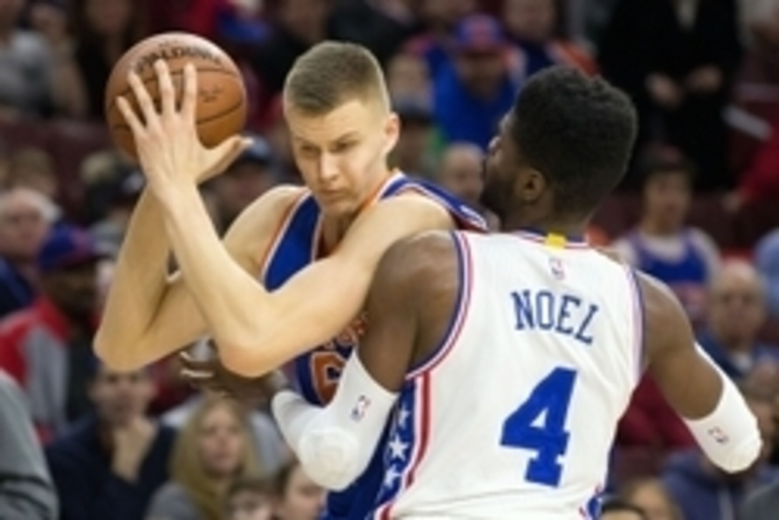 Dec 18, 2015; Philadelphia, PA, USA; New York Knicks forward Kristaps Porzingis (6) battles for position against Philadelphia 76ers forward Nerlens Noel (4) during the first quarter at Wells Fargo Center. Mandatory Credit: Bill Streicher-USA TODAY Sports