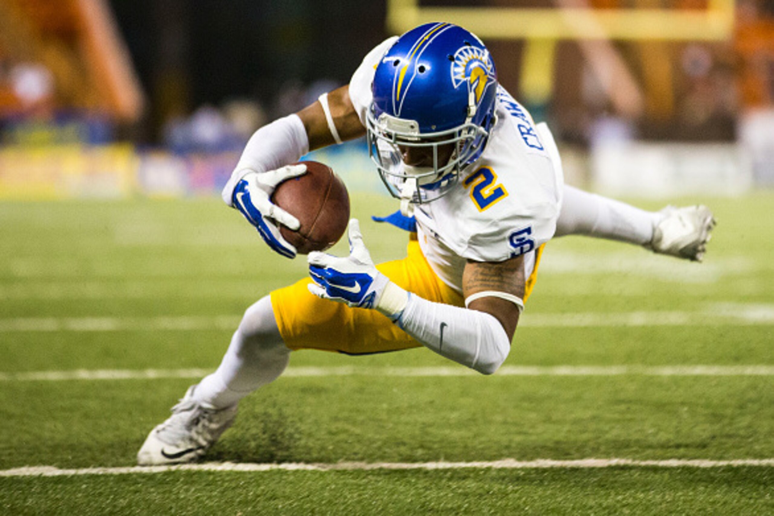 HONOLULU, HI -  SATURDAY, NOVEMBER 21:  Tim Crawley #2 of the San Jose State Spartans dives into the end zone for a touchdown against the Hawaii Warriors during the first quarter of a college football game at Aloha Stadium on November 21, 2015 in Honolulu
