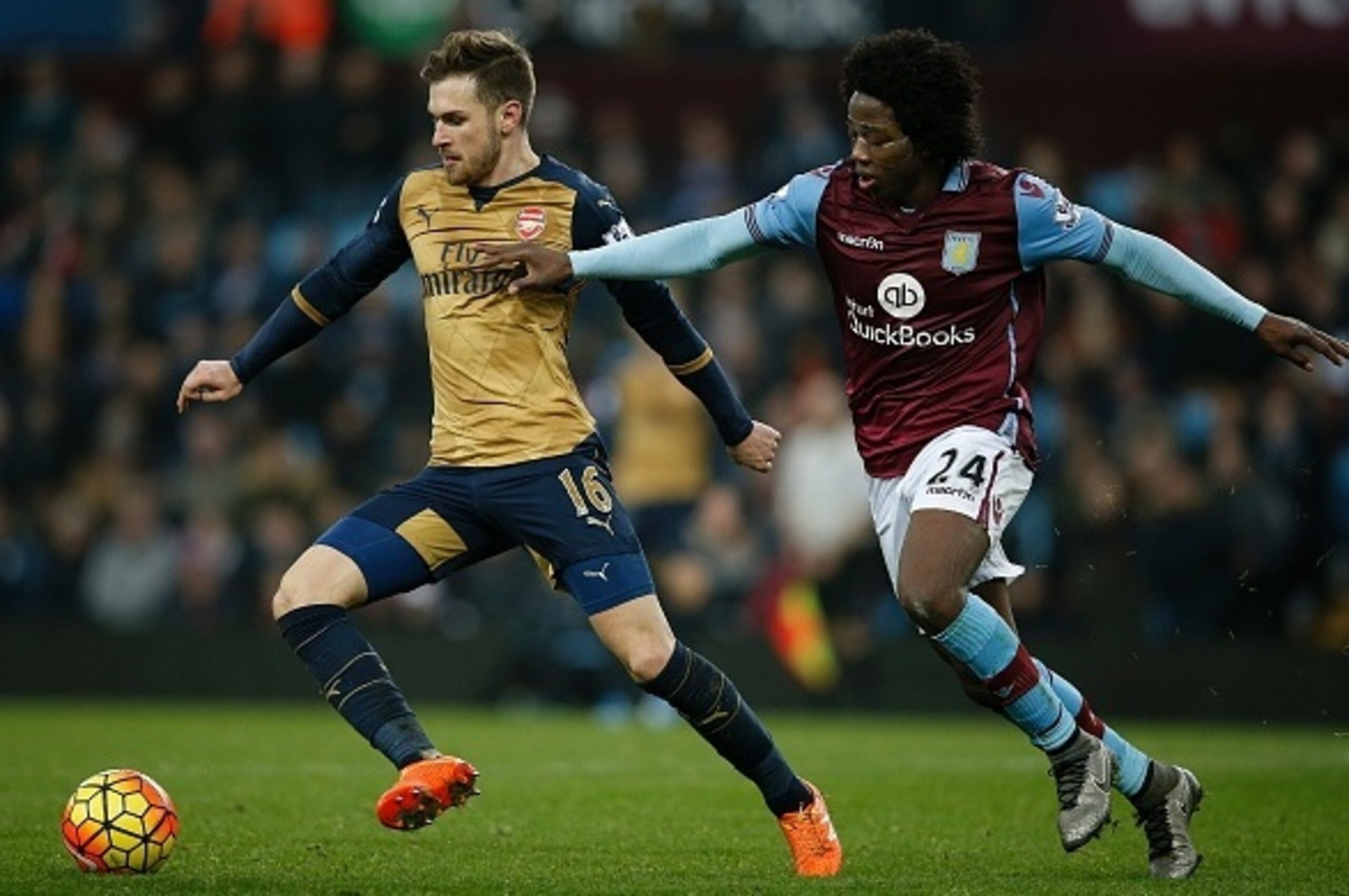 Arsenal's Welsh midfielder Aaron Ramsey (L) vies with Aston Villa's Colombian midfielder Carlos Sanchez during the English Premier League football match between Aston Villa and Arsenal at Villa Park in Birmingham, central England on December 13, 2015.  AF