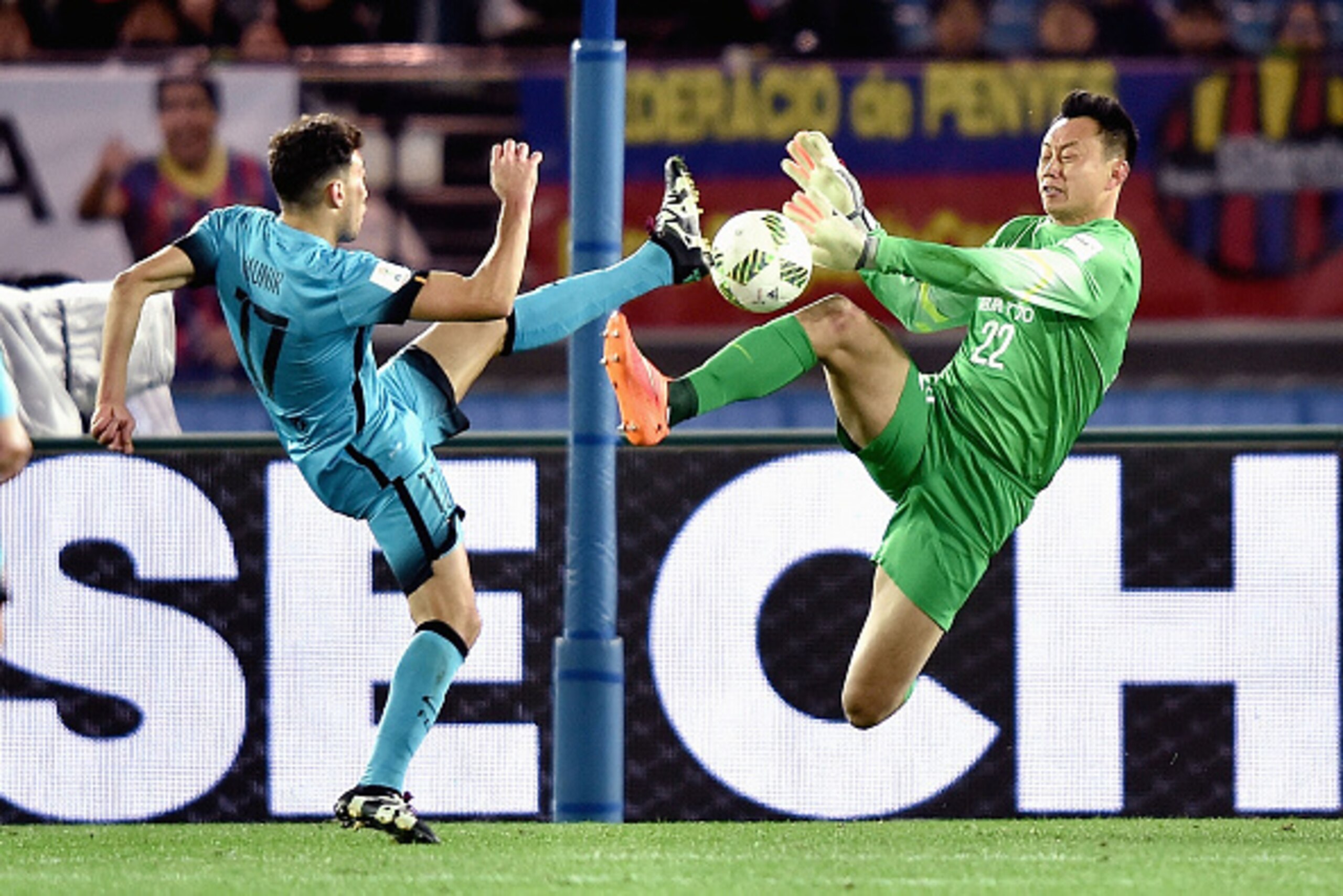 YOKOHAMA, JAPAN - DECEMBER 17:  Li Shuai #22 of Guangzhou Evergrande and Munir El Haddadi #17 of Barcelona competes for the ball during the FIFA Club World Cup Semi Final match between Barcelona and Guangzhou Evergrande FC at International Stadium Yokoham