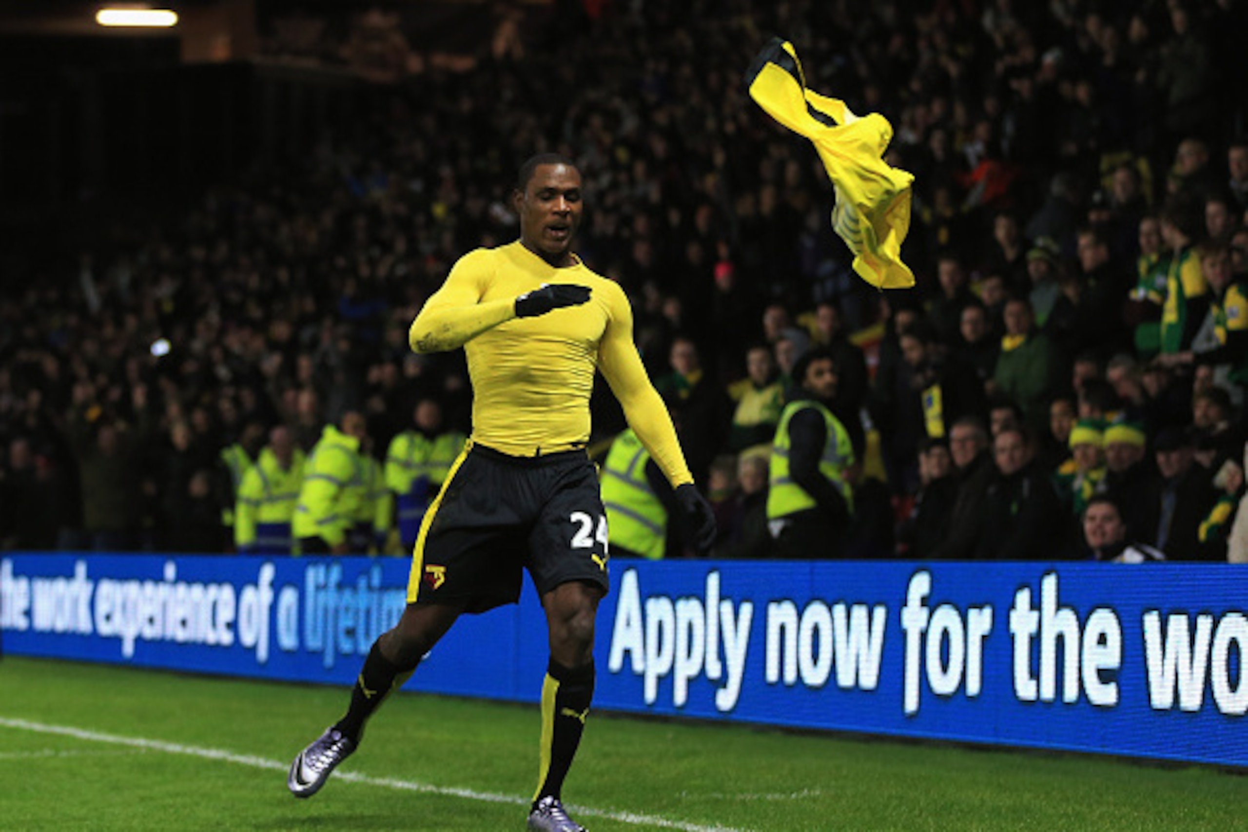 WATFORD, ENGLAND - DECEMBER 05:  Odion Ighalo of Watford takes off his shirt to celebrate scoring his team's second goal during the Barclays Premier League match between Watford and Norwich City at Vicarage Road on December 5, 2015 in Watford, England.  (