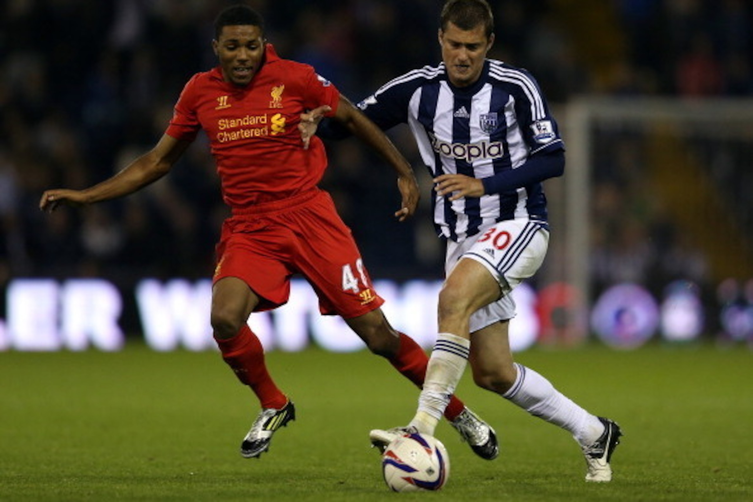 WEST BROMWICH, ENGLAND - SEPTEMBER 26:  Jerome Sinclair of Liverpool battles with Gabriel Tamas of West Brom during the Capital One Cup third round match between West Bromwich Albion and Liverpool at The Hawthorns on September 26, 2012 in West Bromwich, E