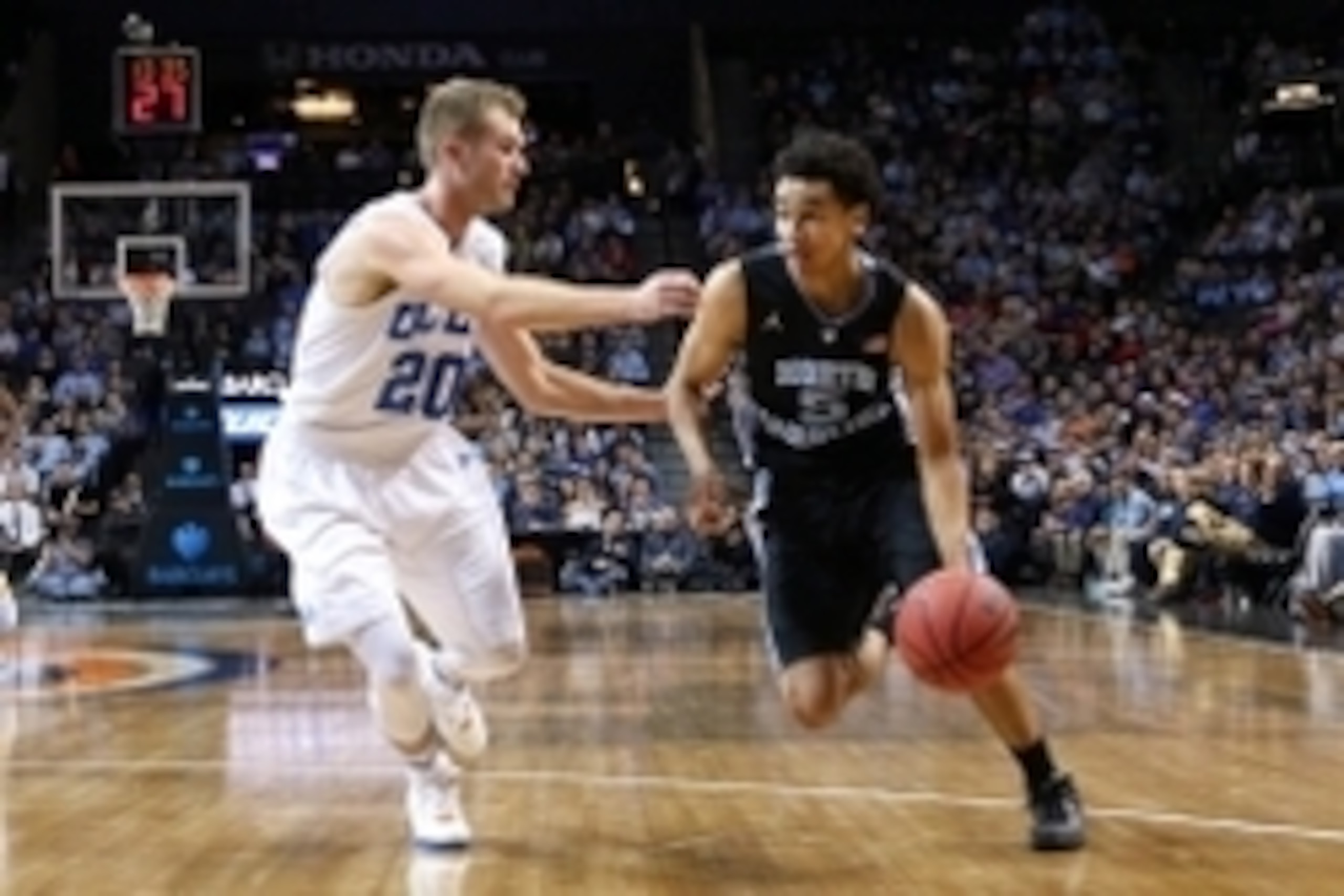 Dec 19, 2015; Brooklyn, NY, USA; North Carolina Tar Heels guard Marcus Paige (5) drives around UCLA Bruins guard Bryce Alford (20) during the second half at Barclays Center. North Carolina Tar Heels won 89-76. Mandatory Credit: Anthony Gruppuso-USA TODAY 