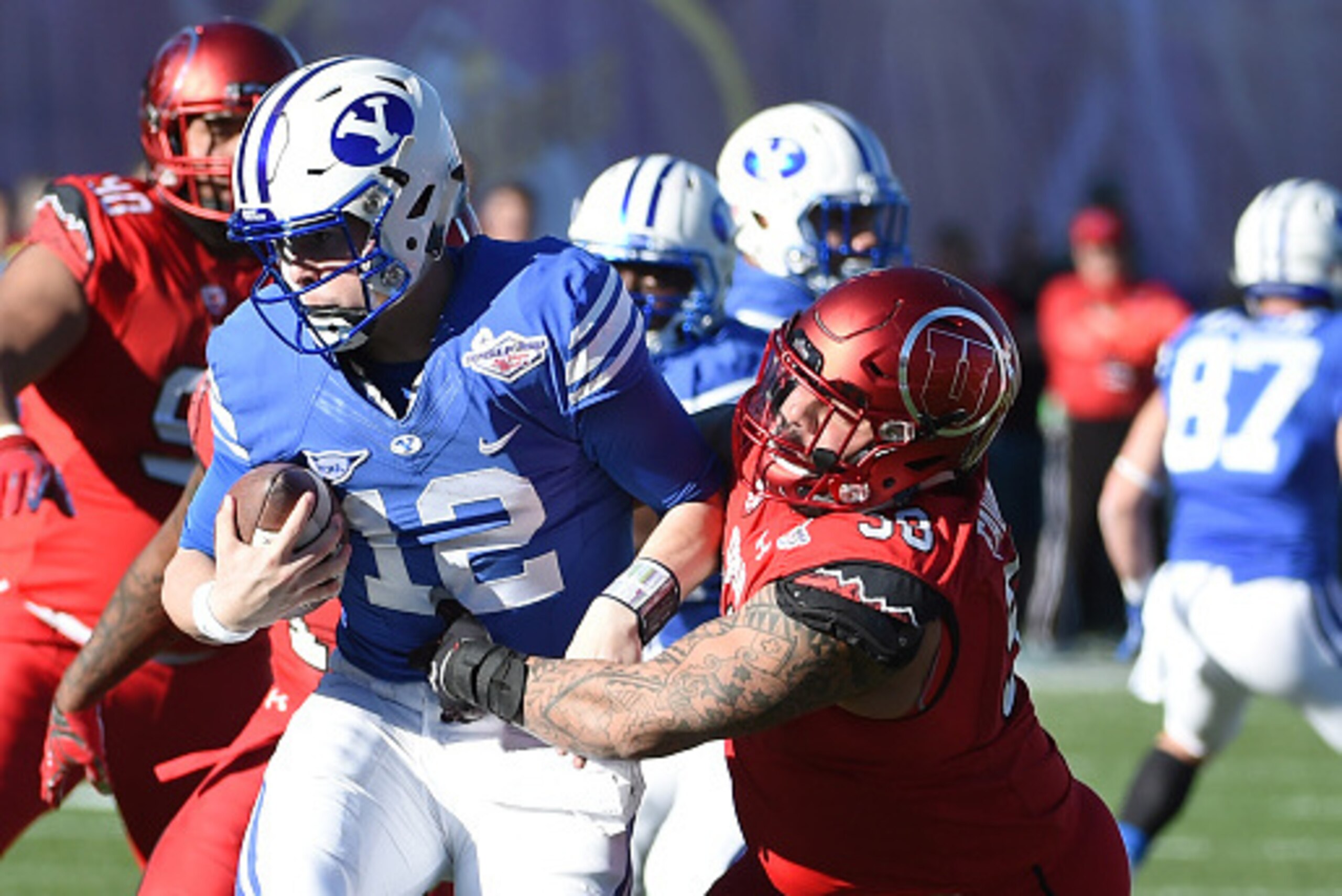 LAS VEGAS, NV - DECEMBER 19:  Defensive tackle Viliseni Fauonuku #98 of the Utah Utes sacks quarterback Tanner Mangum #12 of the Brigham Young Cougars during the Royal Purple Las Vegas Bowl at Sam Boyd Stadium on December 19, 2015 in Las Vegas, Nevada.  (