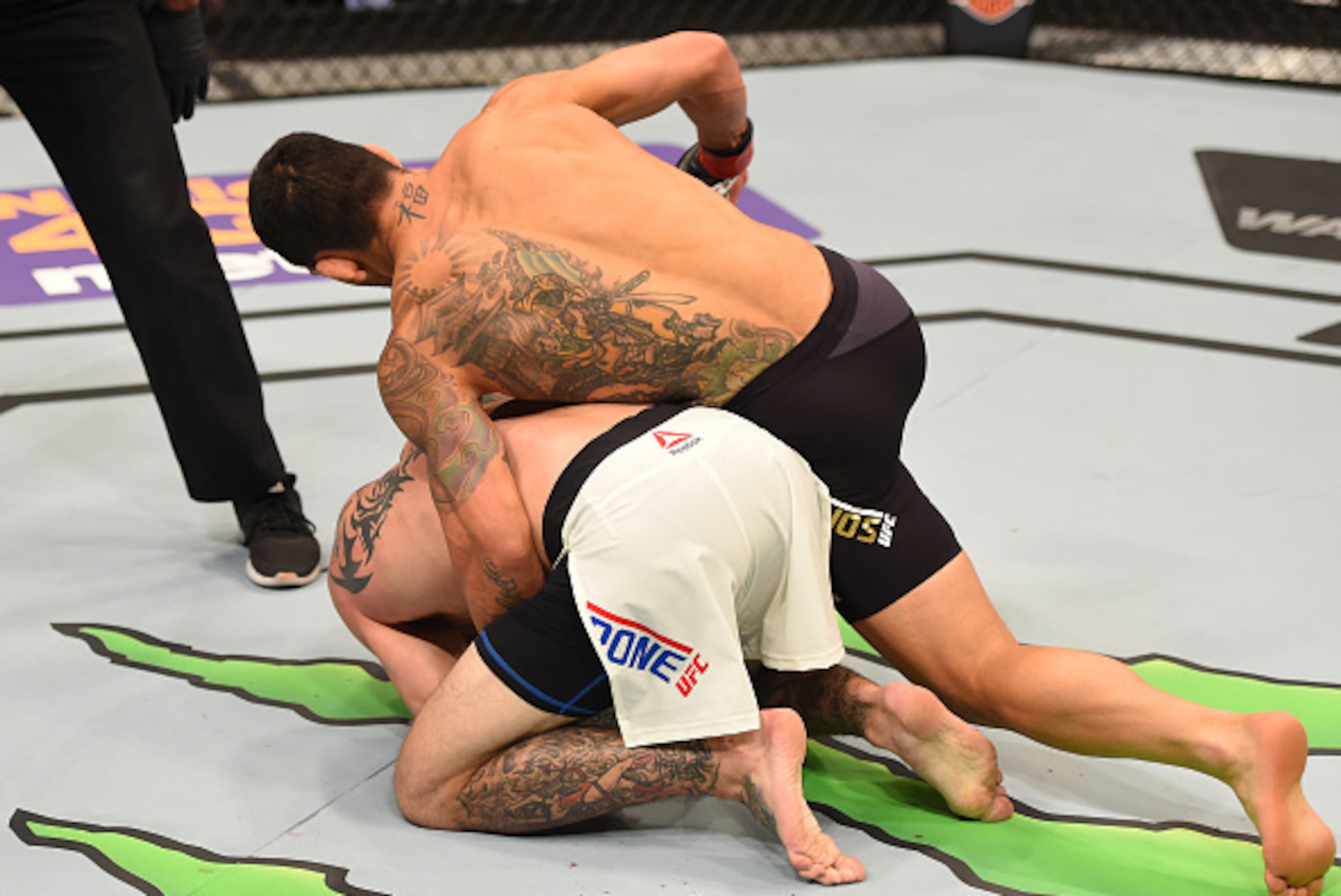 ORLANDO, FL - DECEMBER 19:   Rafael dos Anjos (top) punches Donald Cerrone in their UFC lightweight title bout during the UFC Fight Night event at the Amway Center on December 19, 2015 in Orlando, Florida. (Photo by Josh Hedges/Zuffa LLC/Zuffa LLC via Get