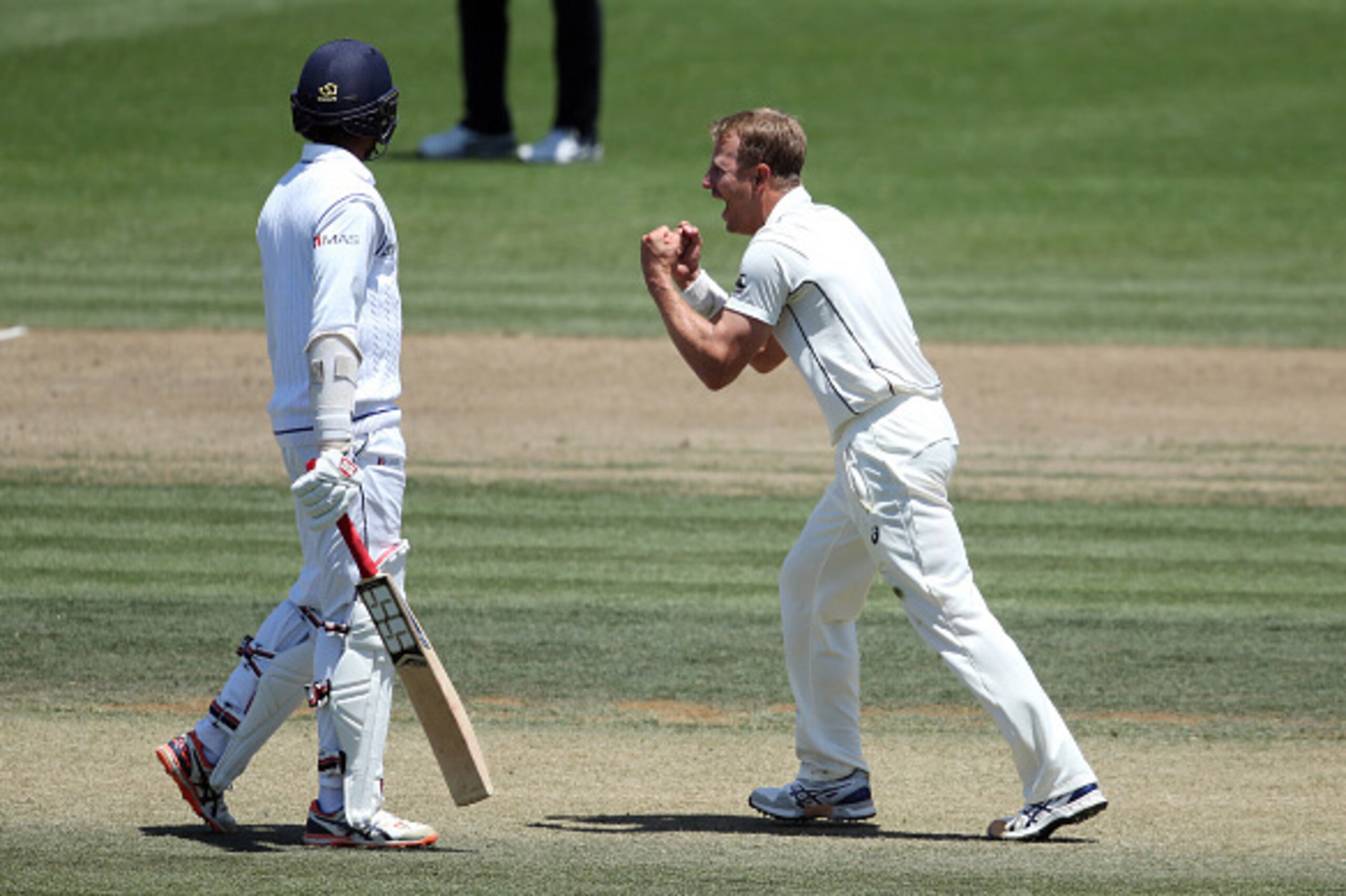 Neil Wagner of New Zealand (R) celebrates the wicket of Kithuruwan Vithanage of Sri Lanka (L) during day three of the second Test cricket match between New Zealand and Sri Lanka at Seddon Park in Hamilton on December 20, 2015.       AFP PHOTO / MICHAEL BR