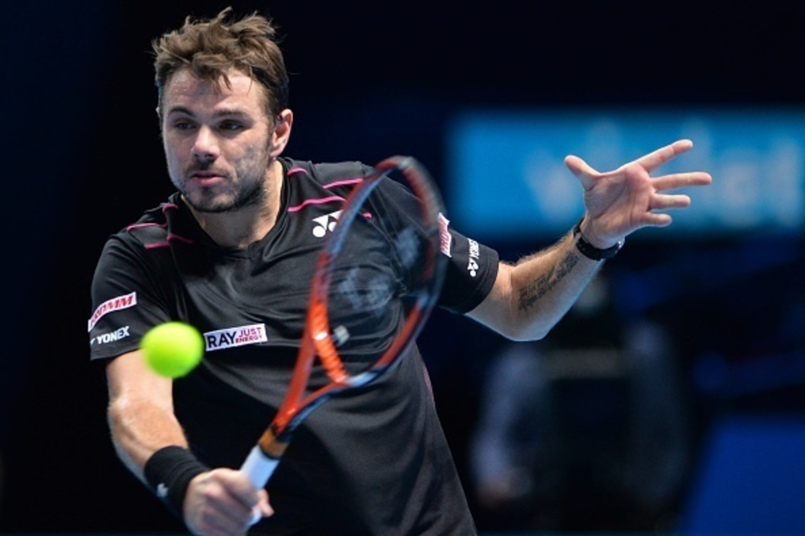 Switzerland's Stan Wawrinka returns to Switzerland's Roger Federer during the men's singles semi-final match on day seven of the ATP World Tour Finals tennis tournament in London on November 21, 2015. 
AFP PHOTO / GLYN KIRK        (Photo credit should rea