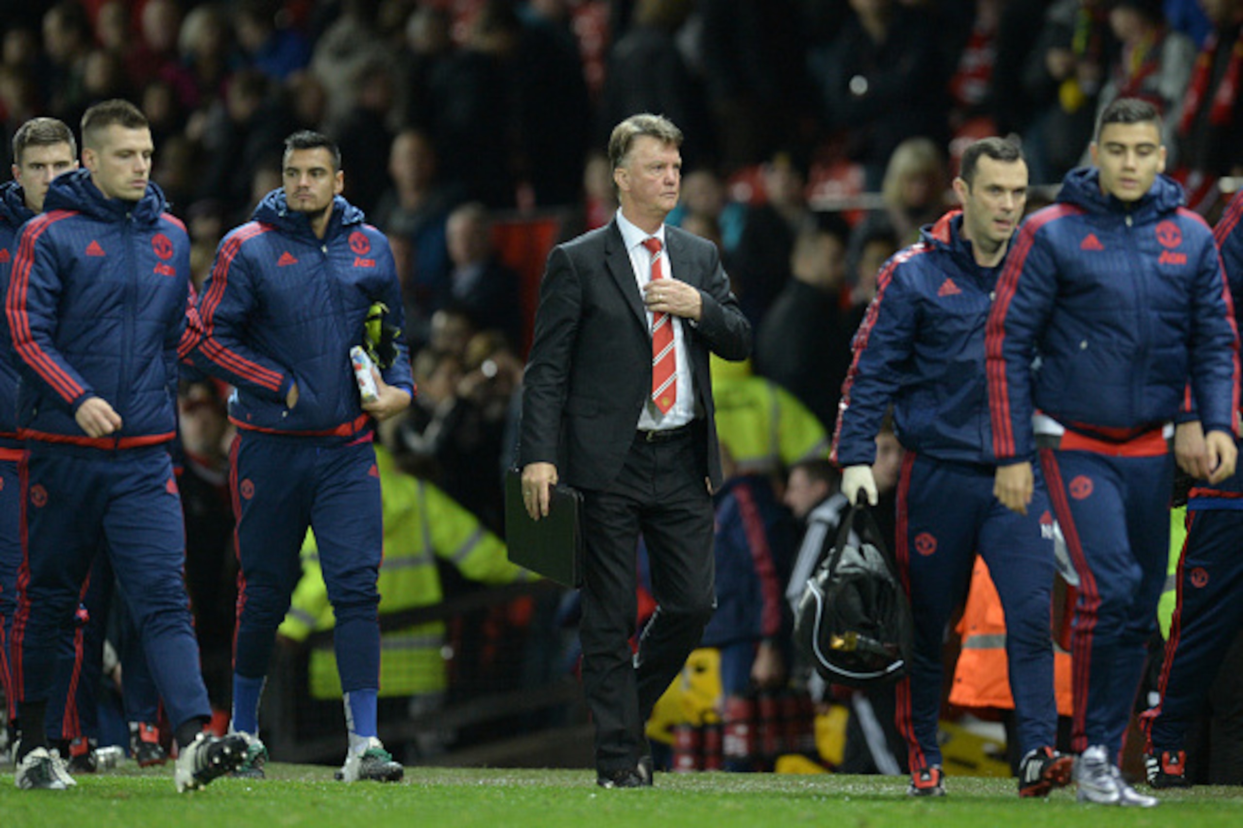 Manchester United's Dutch manager Louis van Gaal (C) leaves the pitch after the English Premier League football match between Manchester United and Norwich City at Old Trafford in Manchester, north west England on December 19, 2015. Norwich won the game 2
