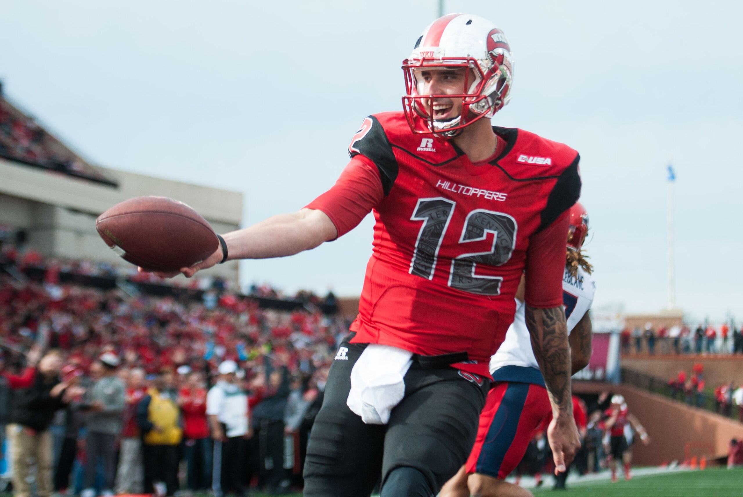 Nov 7, 2015; Bowling Green, KY, USA; Western Kentucky Hilltoppers quarterback Brandon Doughty (12) scores a touchdown during the second half against the Florida Atlantic Owls at Houchens Industries-L.T. Smith Stadium. Western Kentucky won 35-19. Mandatory