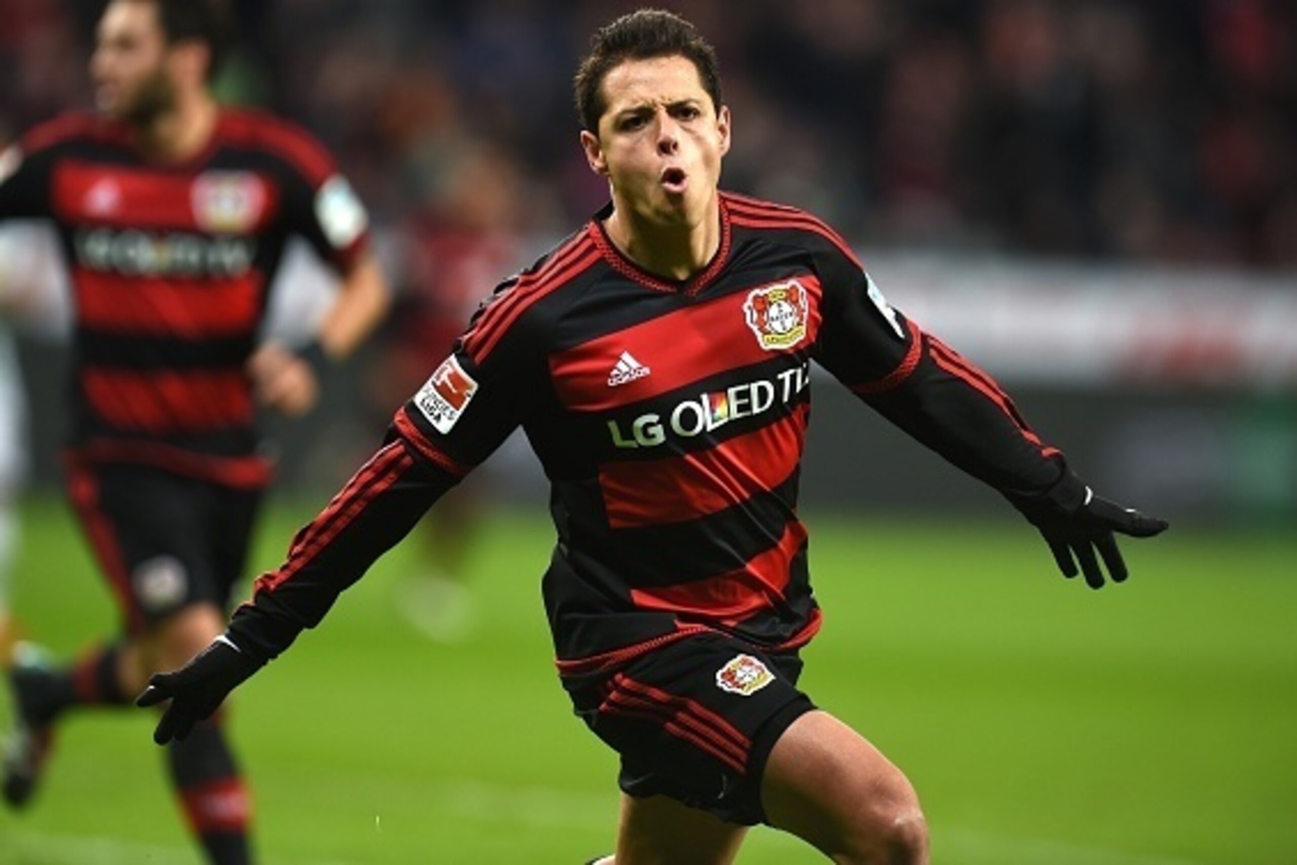 Leverkusen's Mexican striker Javier Hernandez celebrates after scoring his team's second goal during the German first division Bundesliga football match Bayer 04 Leverkusen vs Borussia Moenchengladbach in Leverkusen, western Germany, on December 12, 2015.