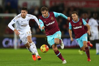SWANSEA, WALES - DECEMBER 20:  Nikica Jelavic of West Ham is pursued by Federico Fernandez of Swansea City during the Barclays Premier League match between Swansea City and West Ham United at the Liberty Stadium on December 20, 2015 in Swansea, Wales.  (P