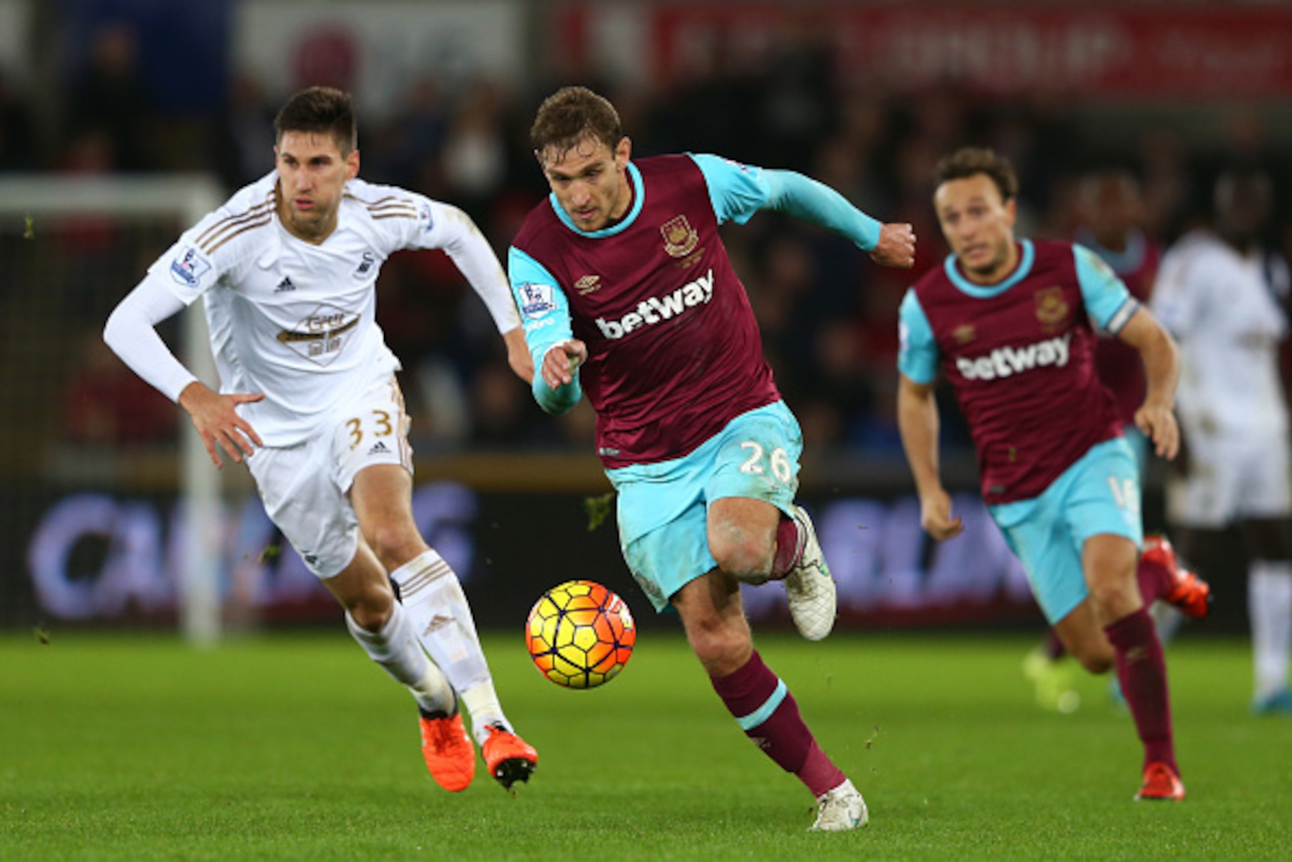 SWANSEA, WALES - DECEMBER 20:  Nikica Jelavic of West Ham is pursued by Federico Fernandez of Swansea City during the Barclays Premier League match between Swansea City and West Ham United at the Liberty Stadium on December 20, 2015 in Swansea, Wales.  (P