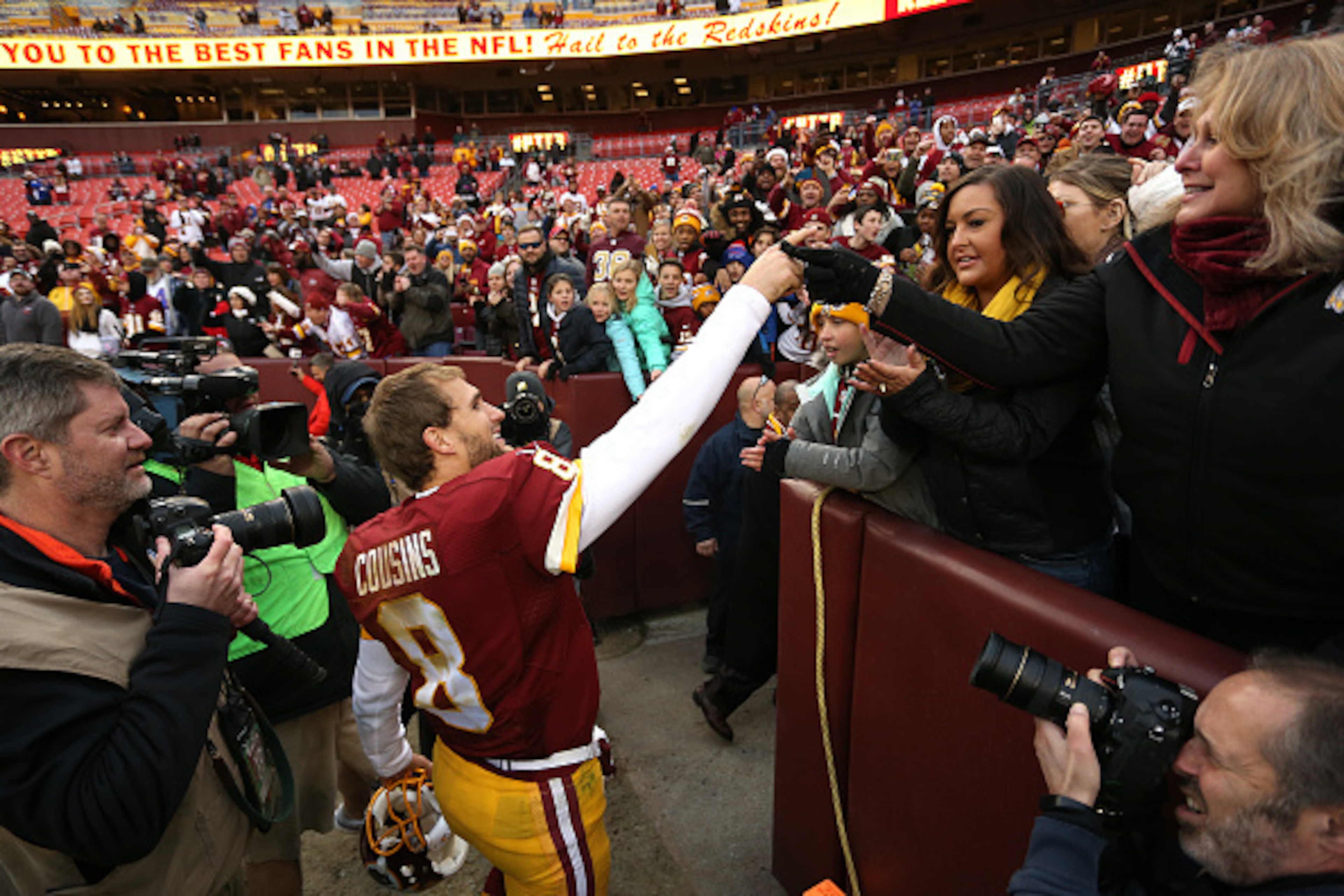 LANDOVER, MD - DECEMBER 20: Quarterback Kirk Cousins #8 of the Washington Redskins celebrates with fans after the Washington Redskins defeated the Buffalo Bills 35-25 at FedExField on December 20, 2015 in Landover, Maryland. (Photo by Matt Hazlett/Getty I LANDOVER, MD - DECEMBER 20: Quarterback Kirk Cousins #8 of the Washington Redskins celebrates with fans after the Washington Redskins defeated the Buffalo Bills 35-25 at FedExField on December 20, 2015 in Landover, Maryland. (Photo by Matt Hazlett/Getty I