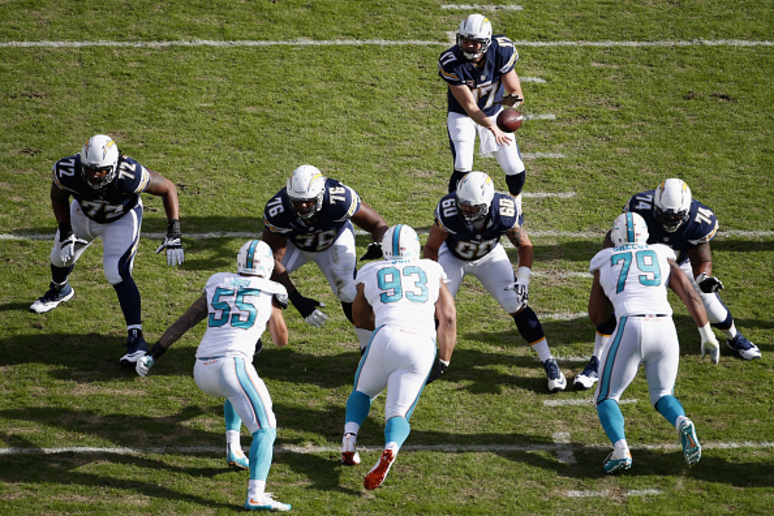 SAN DIEGO, CA - DECEMBER 20:  Philip Rivers #17 of the San Diego Chargers passes against the Miami Dolphins defense at Qualcomm Stadium on December 20, 2015 in San Diego, California.  (Photo by Todd Warshaw/Getty Images)