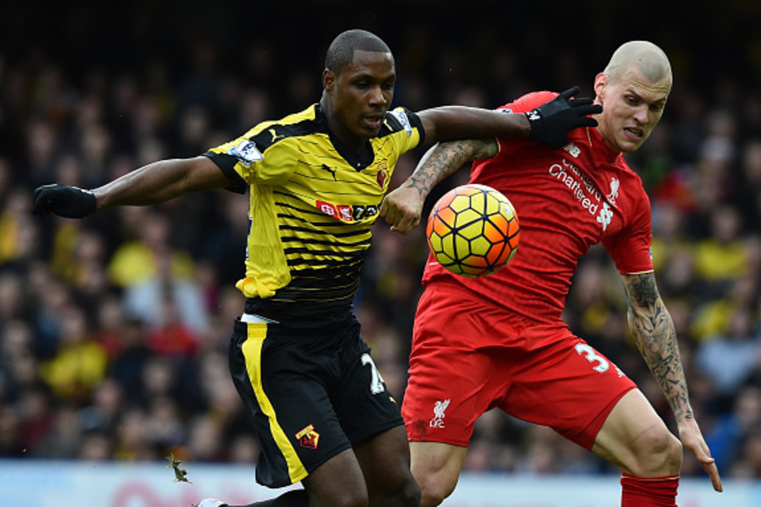 Watford's Nigerian striker Odion Ighalo (L) vies with Liverpool's Slovakian defender Martin Skrtel before scoring their second goal during the English Premier League football match between Watford and Liverpool at Vicarage Road Stadium in Watford, north o