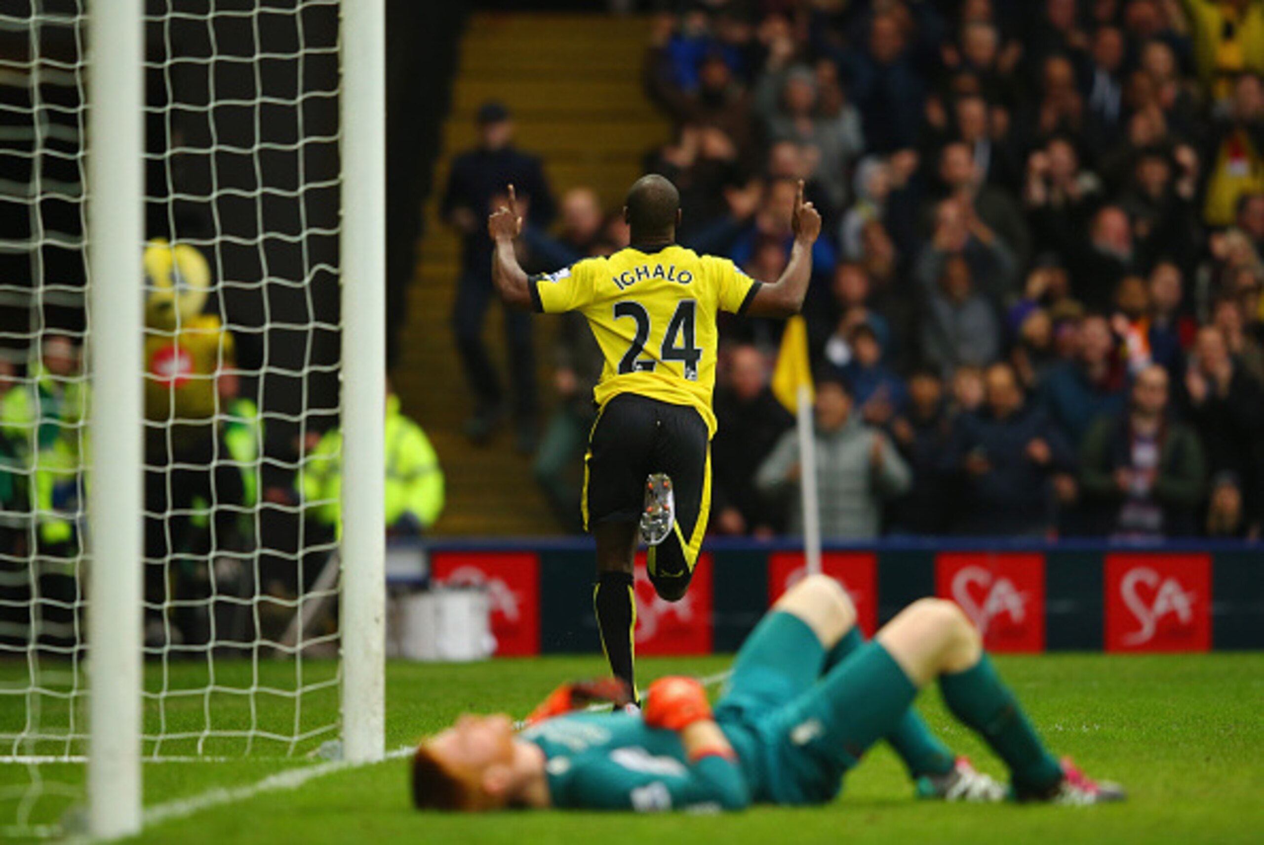 WATFORD, ENGLAND - DECEMBER 20:  Adam Bogdan of Liverpool (front) looks dejected as Odion Ighalo of Watford celebrates as he scores their third goal during the Barclays Premier League match between Watford and Liverpool at Vicarage Road on December 20, 20