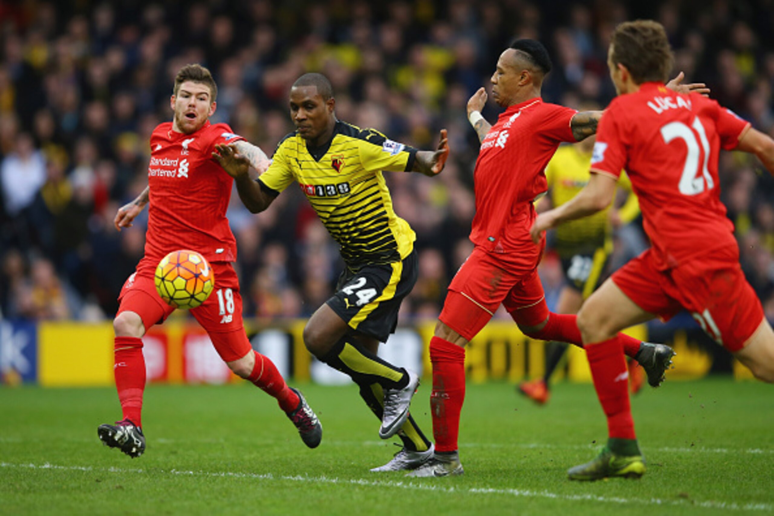 WATFORD, ENGLAND - DECEMBER 20:  Odion Ighalo of Watford takes on Alberto Moreno (L), Lucas Leiva (2R) and Nathaniel Clyne of Liverpool (R) during the Barclays Premier League match between Watford and Liverpool at Vicarage Road on December 20, 2015 in Wat