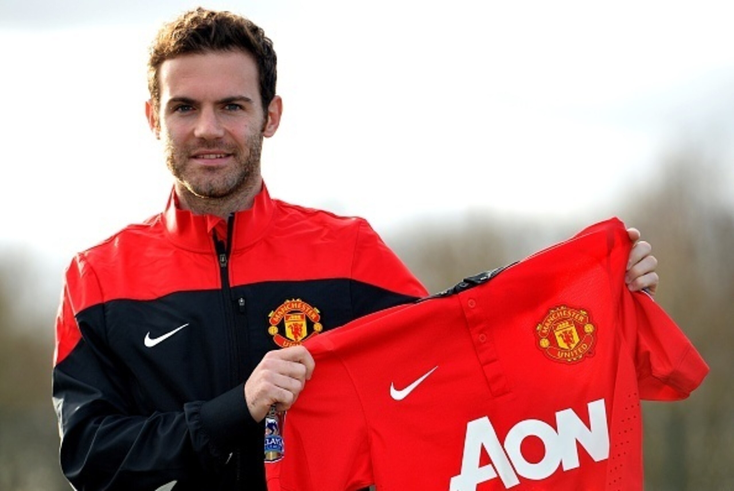 Manchester United's new signing Spanish midfielder Juan Mata poses for photographers at the club training ground in Manchester, north west England, on January 27, 2014. Manchester United manager David Moyes said on January 26 that the club-record acquisit