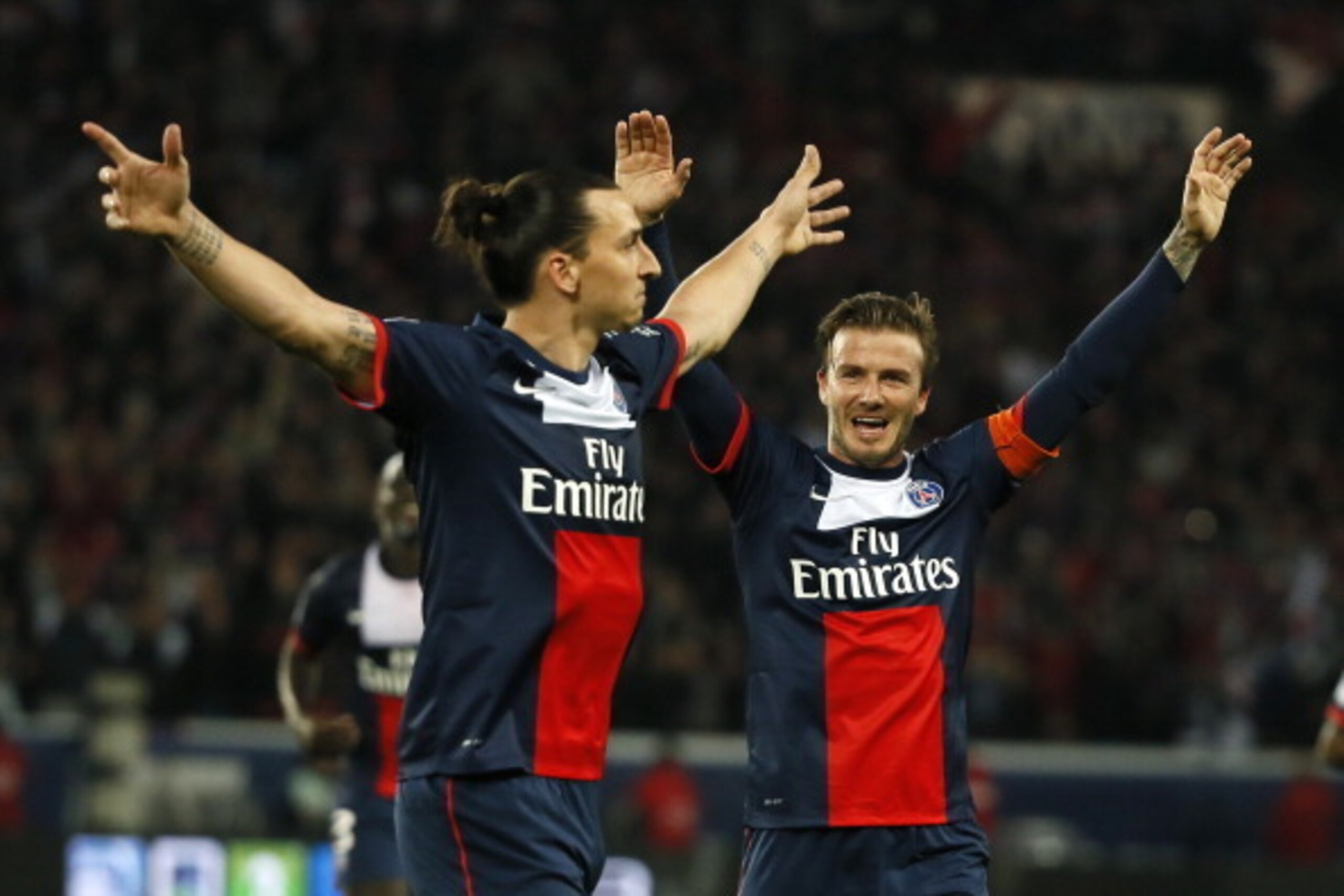 Paris Saint-Germain's Swedish forward Zlatan Ibrahimovic (L) celebrates with Paris Saint-Germain's English midfielder David Beckham after scoring during a French L1 football match between Paris St Germain and Brest on May 18, 2013 at Parc des Princes stad
