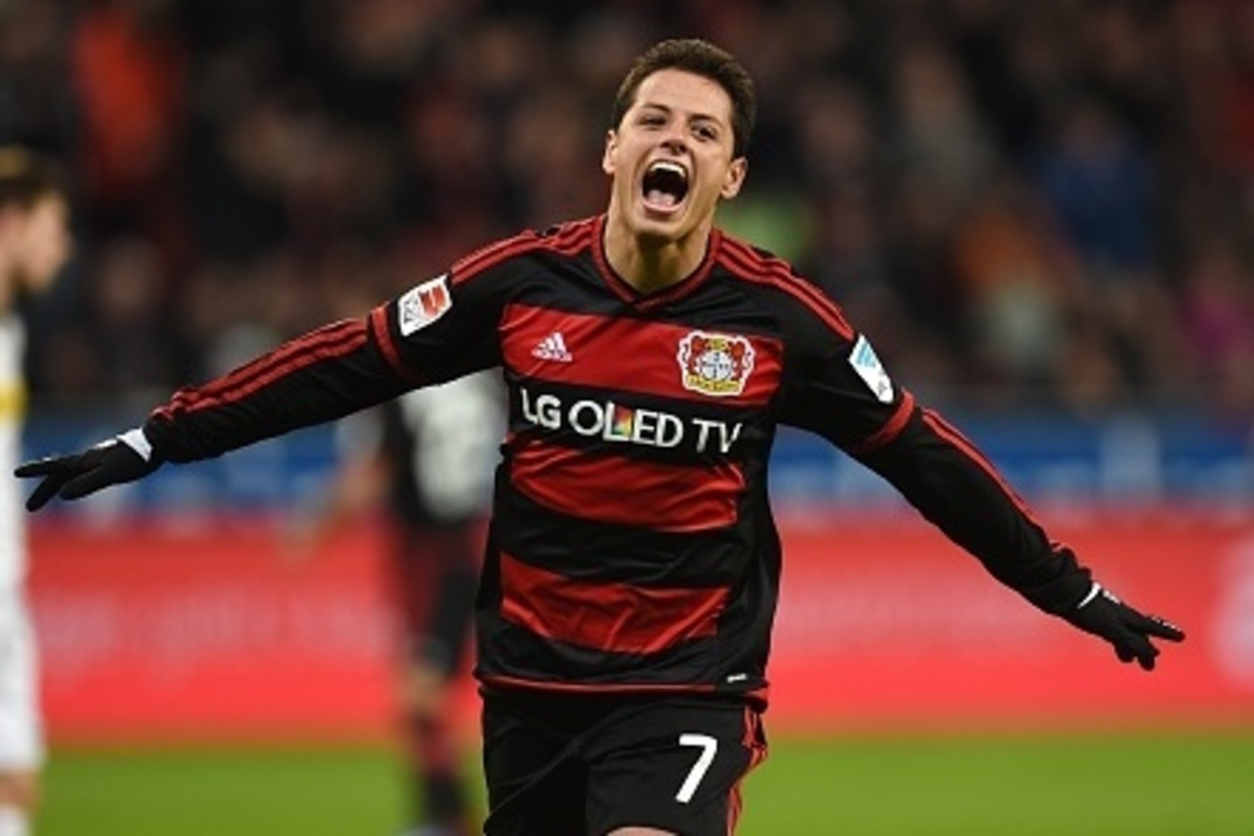 Leverkusen's Mexican striker Javier Hernandez celebrates after scoring during the German first division Bundesliga football match Bayer 04 Leverkusen vs Borussia Moenchengladbach in Leverkusen, western Germany, on December 12, 2015. 
AFP PHOTO / PATRIK ST