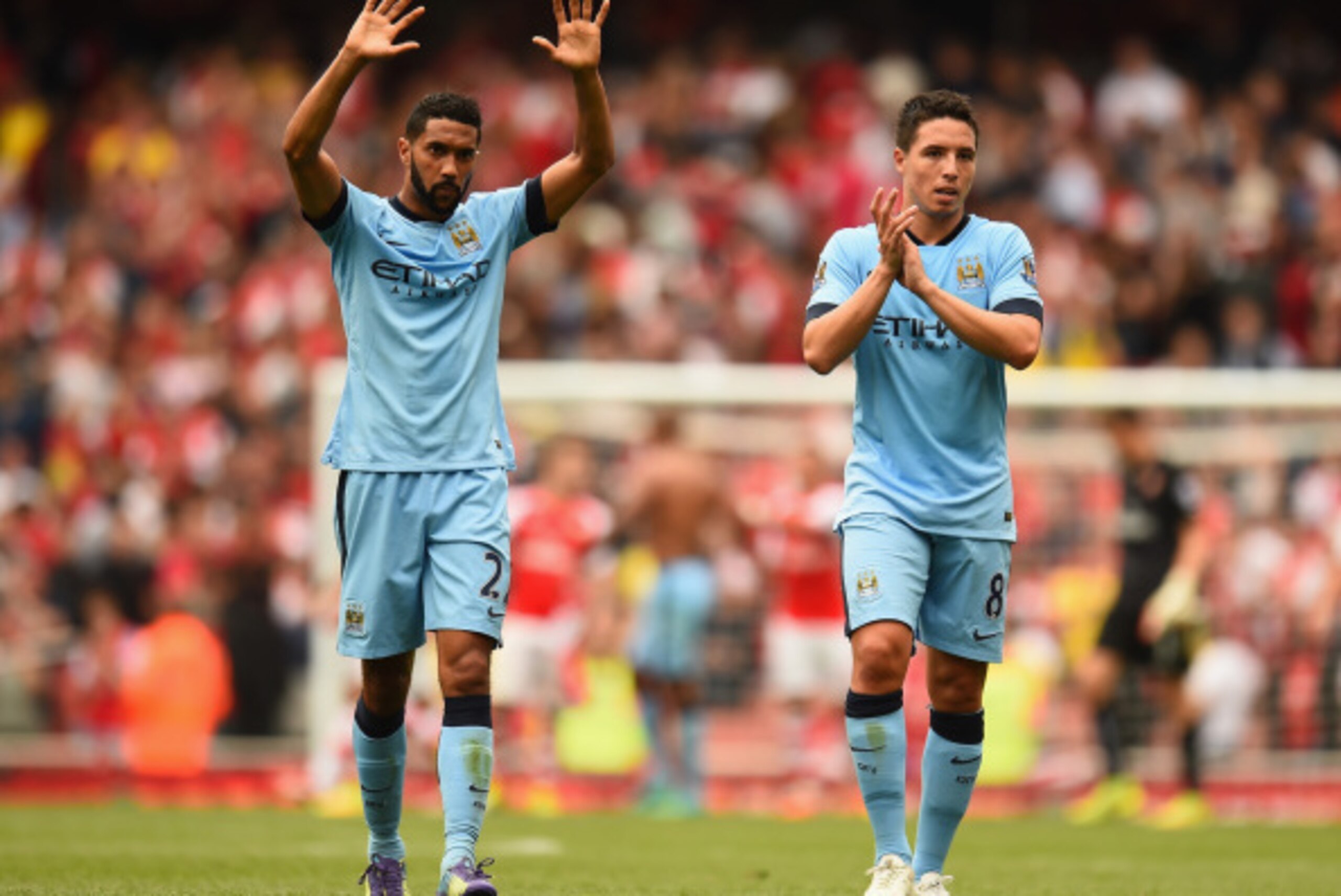 LONDON, ENGLAND - SEPTEMBER 13:  Gael Clichy and Samir Nasri of Manchester City acknowledge the crowd after the Barclays Premier League match between Arsenal and Manchester City at Emirates Stadium on September 13, 2014 in London, England.  (Photo by Shau