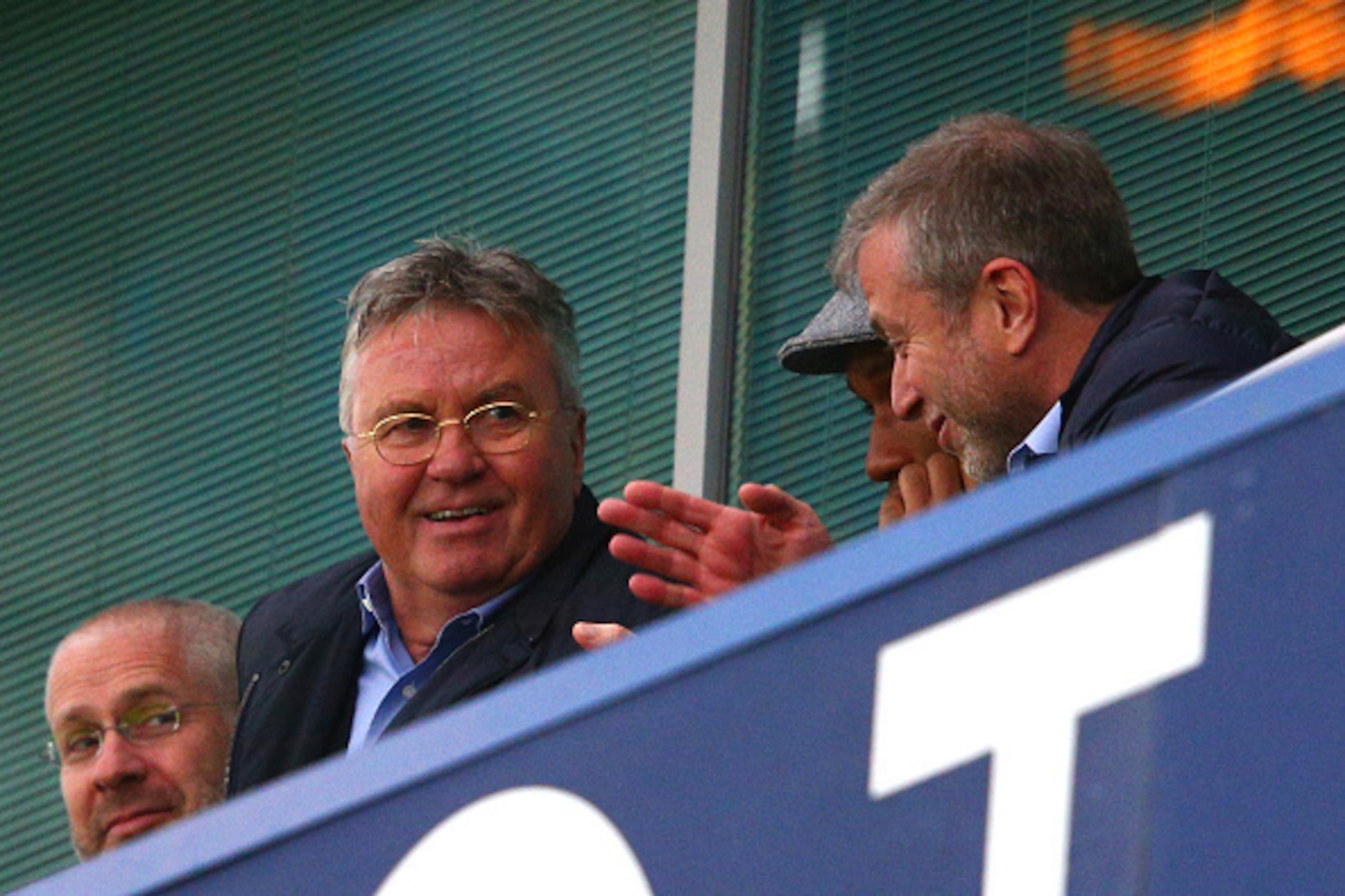 LONDON, ENGLAND - DECEMBER 19:  Chelsea interim manager Guus Hiddink (L), Didier Drogba (C) of Montreal Impact and Chelsea owner Roman Abramovich (R) talk on the stand prior to the Barclays Premier League match between Chelsea and Sunderland at Stamford B